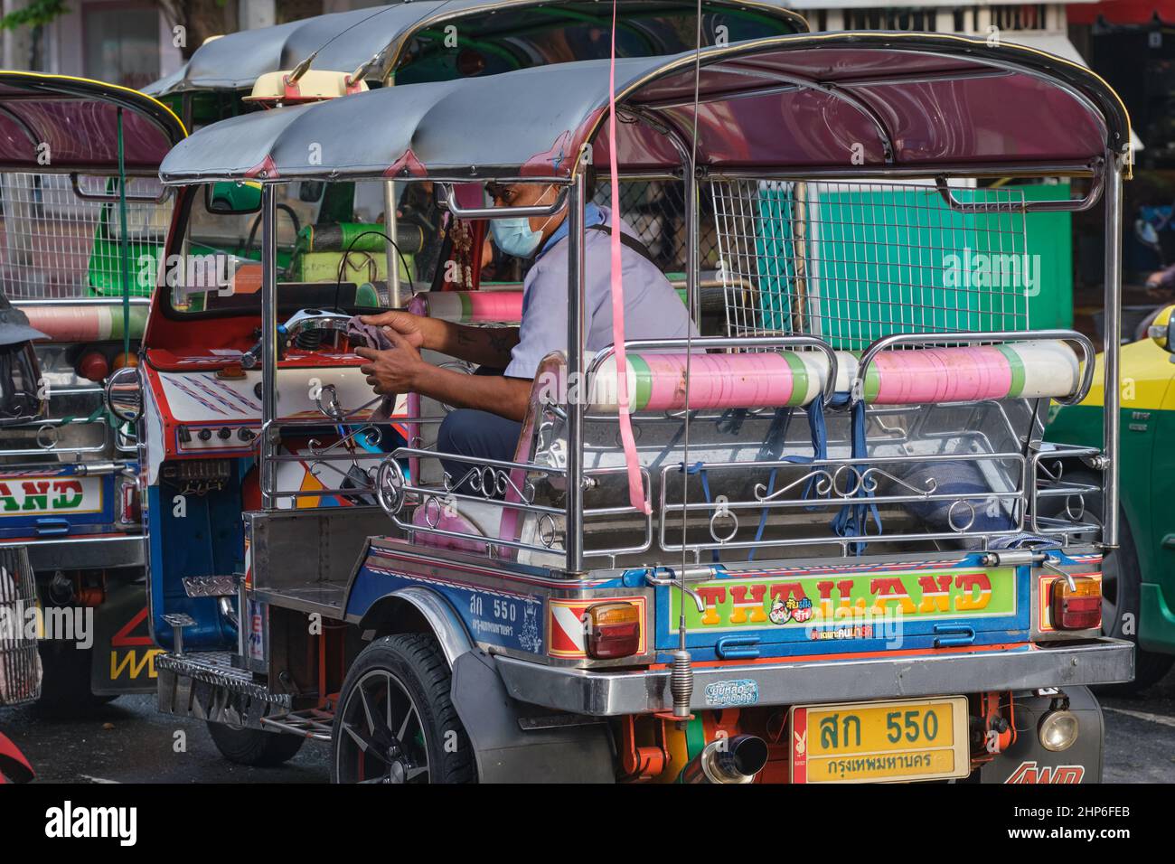 Un tuk-tuk typique (taxi à trois roues) à Bangkok, en Thaïlande, le conducteur appréciant un moment de repos sur le siège arrière Banque D'Images