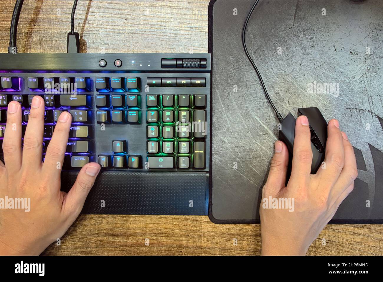 Gros plan mains de joueur qui utilisent le clavier de jeu mécanique et la souris de jeu pour jouer sur ordinateur PC Desktop sur la vue de dessus, e-sport Banque D'Images