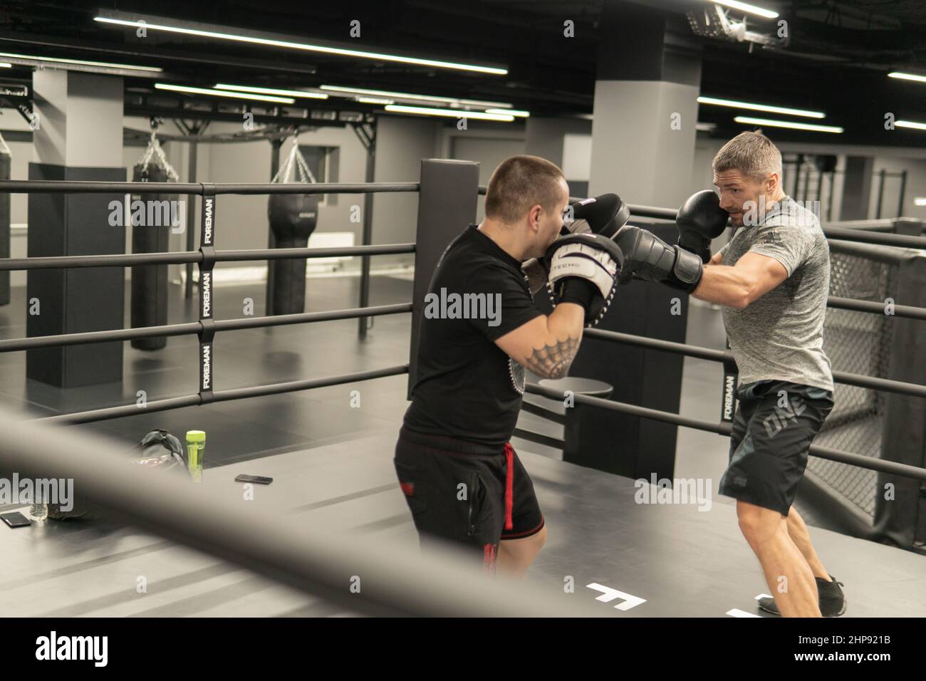 RUSSIE, MOSCOU - 14 FÉVR. 2022: Entraînement de boxe Gym jeunes gants, pour la force kickboxing en compétition de l'agression de puissance, arrière-plan musculaire Banque D'Images