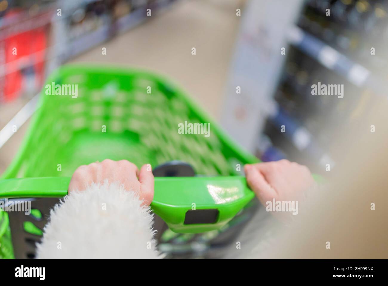 les mains des femmes tiennent un panier pour faire du shopping dans le centre commercial. gros plan partiel. Banque D'Images