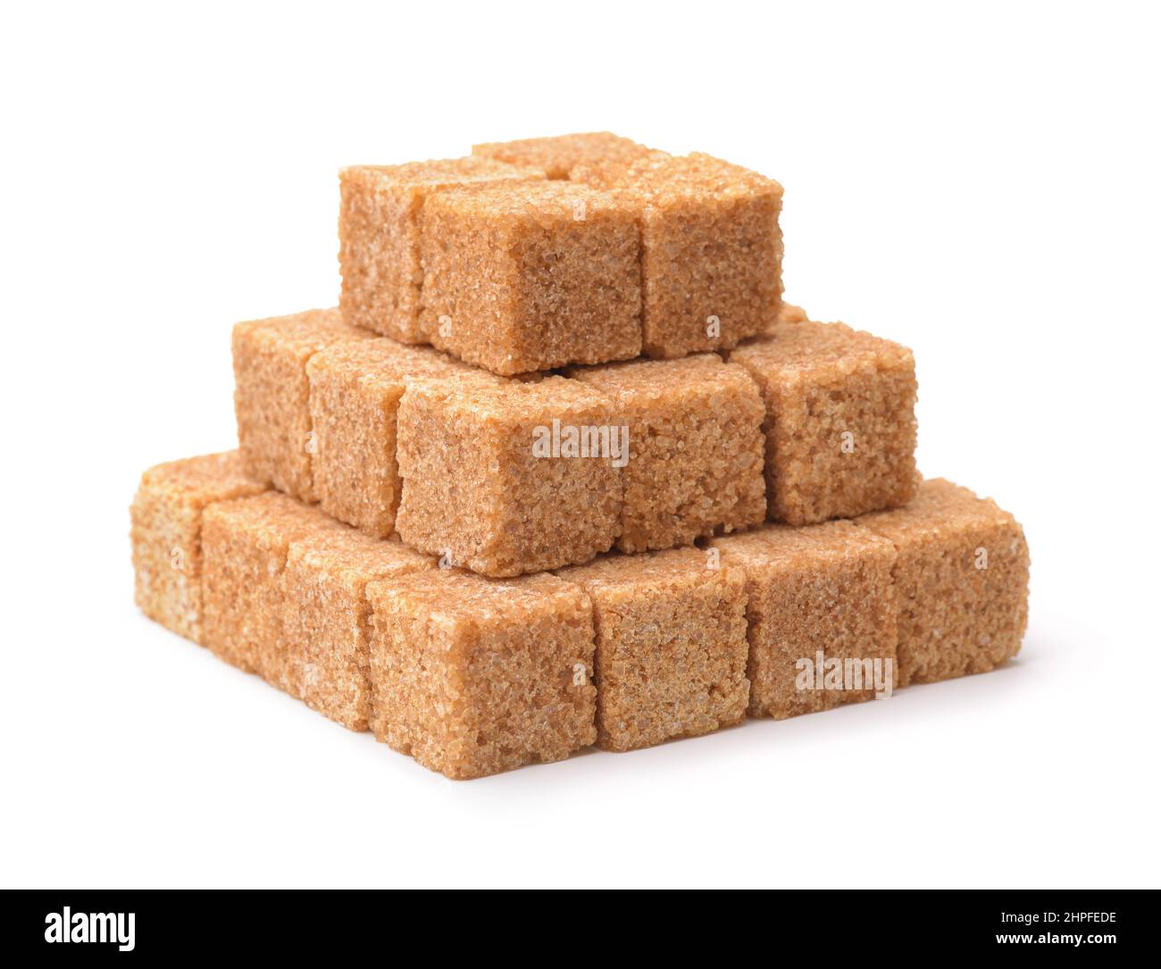Pyramide de cubes de sucre de canne brun non raffiné isolé sur blanc Banque D'Images