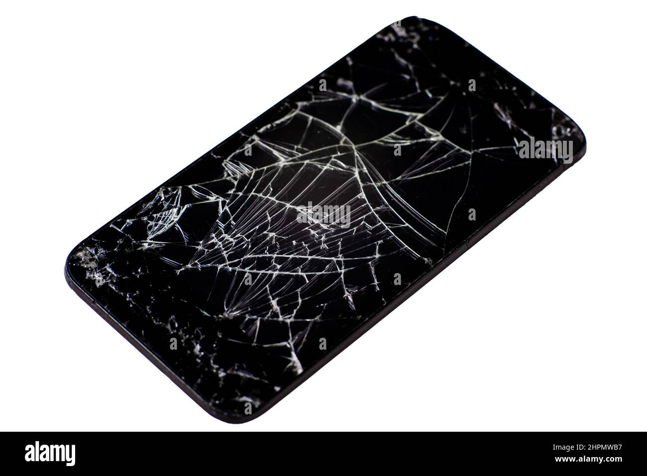 Téléphone mobile cassé isolé sur fond blanc. Nombreuses fissures sur l