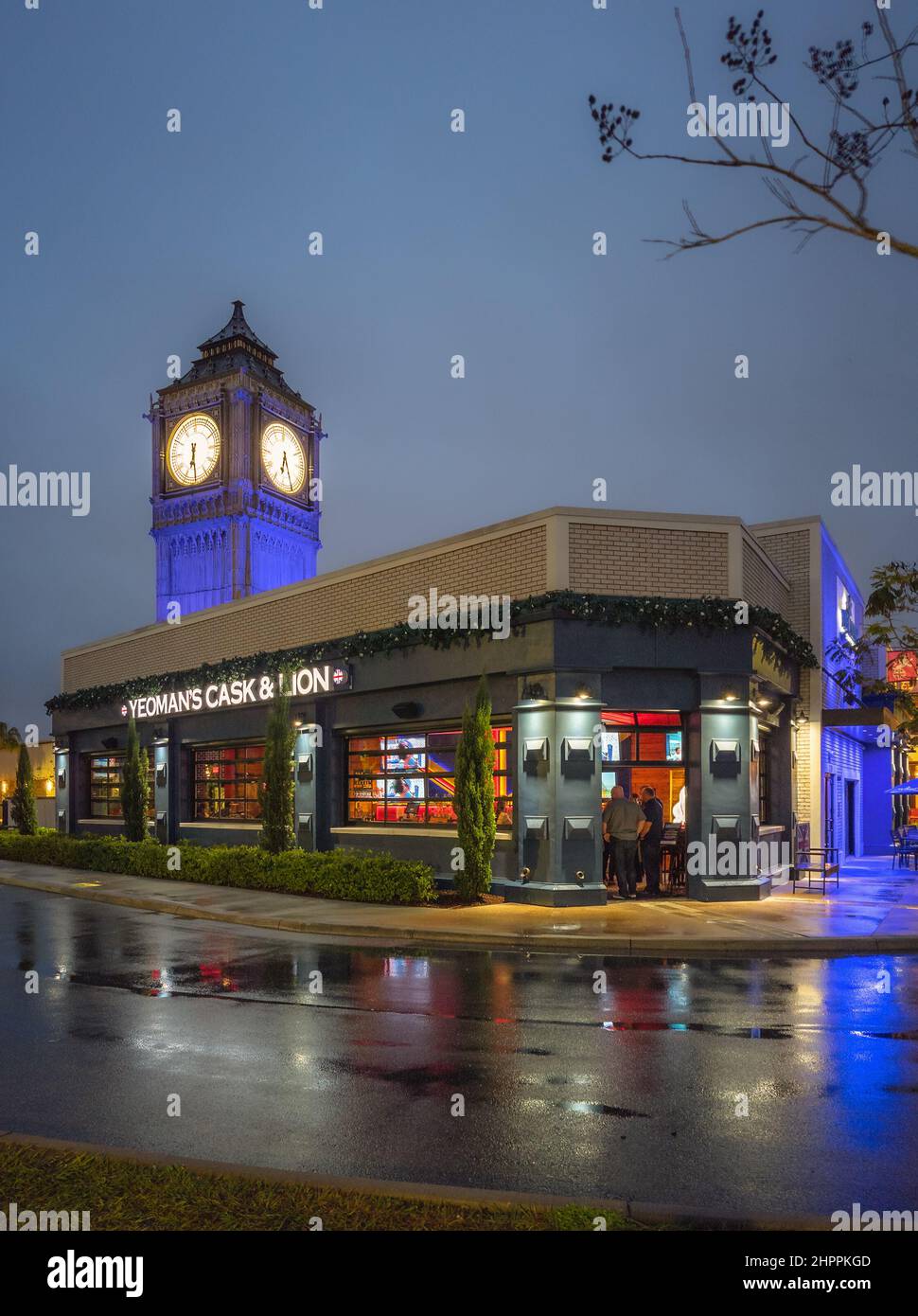 Kissimmee, Floride - 5 février 2022 : vue de nuit verticale du bâtiment complet de Yeoman's Cask & Lion avec Big Pen Mini Tower. Yeoman's est un pub britannique Banque D'Images