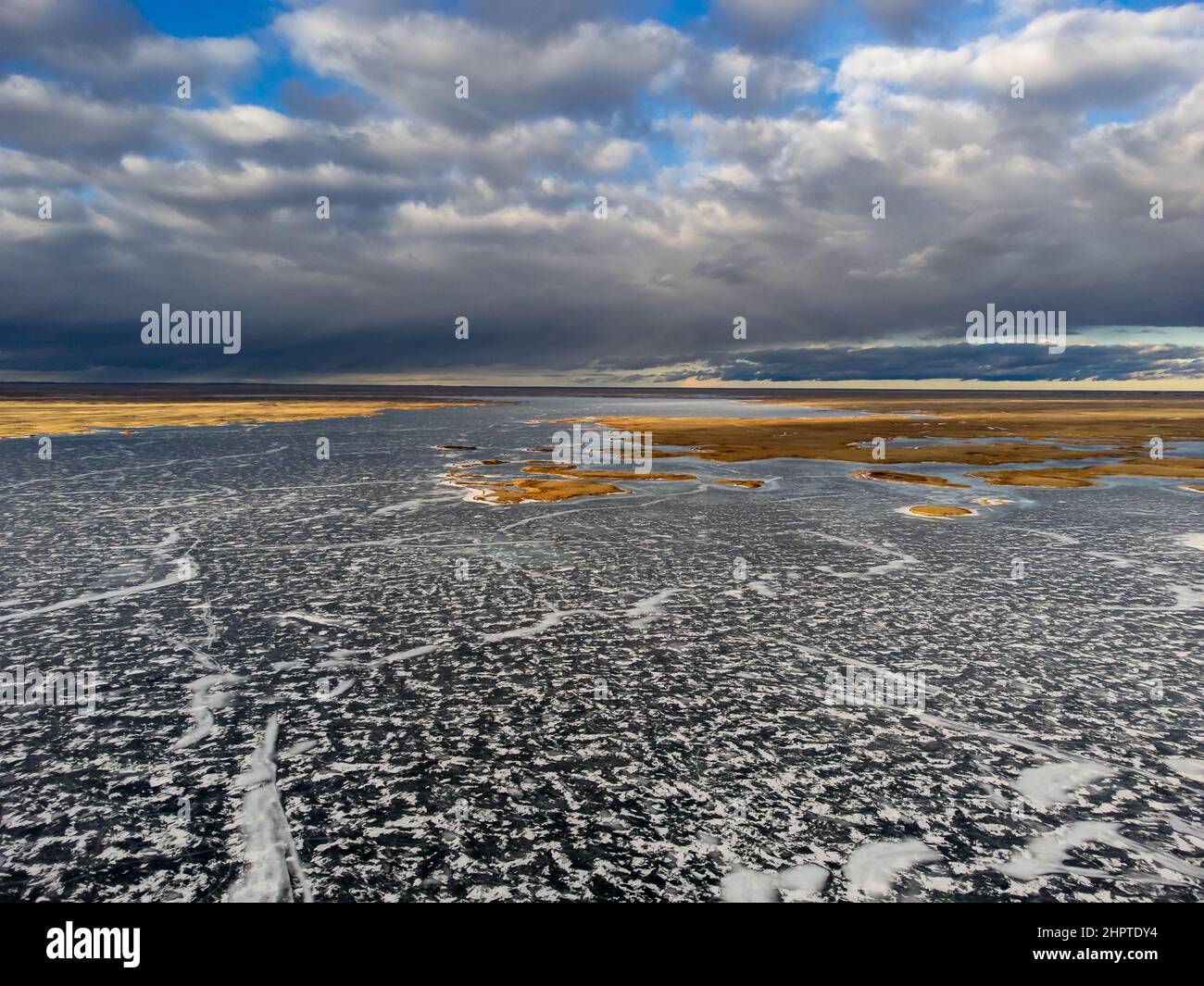 Vue aérienne du réservoir de la vallée de la chenille couverte par la glace et de la toundra gelée pendant l'hiver en Alberta au Canada Banque D'Images