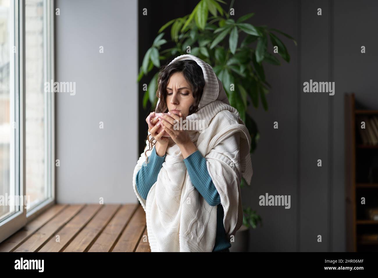 Femme malsaine avec des ganglions lymphatiques enflés ou mal de gorge enveloppé dans du thé chaud à la maison Banque D'Images