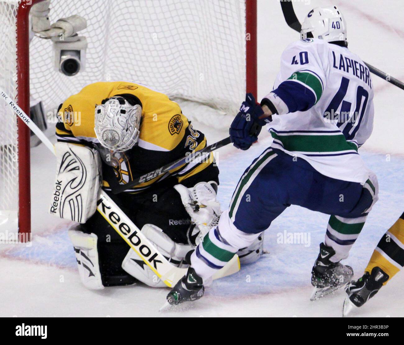 Le gardien de but des Bruins de Boston Tim Thomas fait une économie contre l'aile droite des Canucks de Vancouver Maxim Lapierre lors de la première période du match 4 de la NHL Stanley Cup final hockey action au TD Garden à Boston le mercredi 8 juin 2011. LA PRESSE CANADIENNE/Jonathan Hayward Banque D'Images