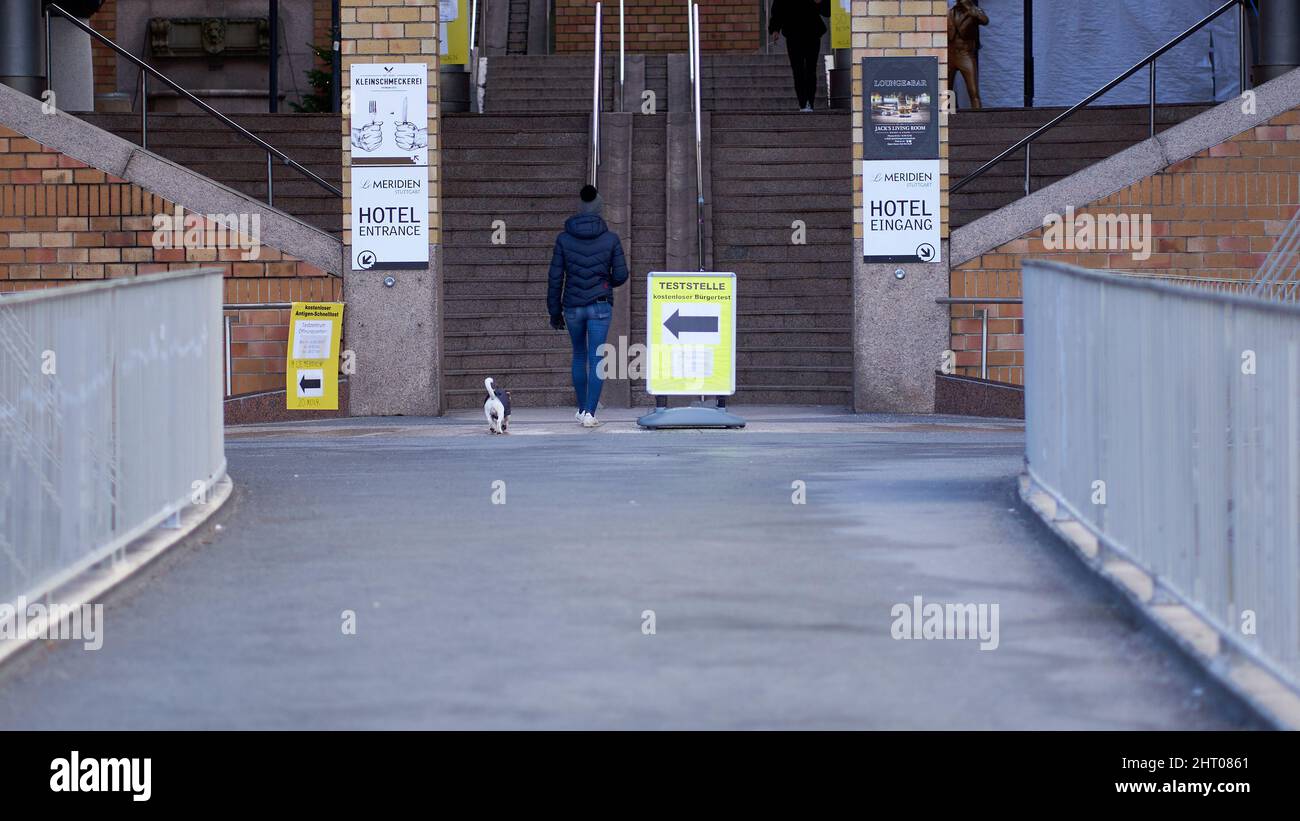 Stuttgart, Allemagne - 06 janvier 2022 : site de test de l'antigène corona de contrôle rapide également pcr. Une jeune femme marche avec son chien. Test des règles 2G plus. Banque D'Images