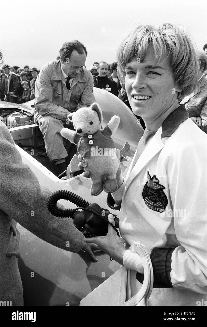 Proteus Bluebird, la voiture dans laquelle Donald Campbell a battu le record mondial de vitesse automobile a maintenant fait sa dernière course, à 5 km/h, à la station RAF, Debden, Essex, 19th juin 1966. Campbell devait faire une démonstration lors d'un gala, Mais 5 jours plus tôt, la voiture a été gravement endommagée quand, avec le pilote de course Peter Bolton aux commandes, elle a heurté une clôture en bois et une haie à 100 km/h, a navigué 10ft dans les airs en traversant la route de Cambridge Chelsford et a finalement tourné sur un terrain de 200 mètres. Également en photo, la femme Tonia Campbell. Banque D'Images