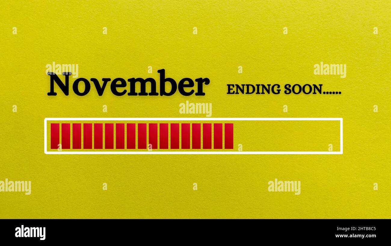 Vue de dessus de la barre de chargement indiquant la fin du mois de novembre avec un fond de papier jaune. Banque D'Images
