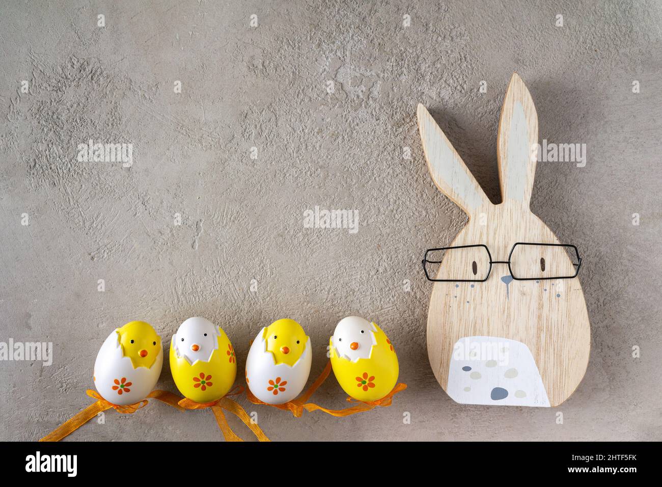 lapin de pâques et œufs de jouet colorés sur un fond gris, copie spa Banque D'Images