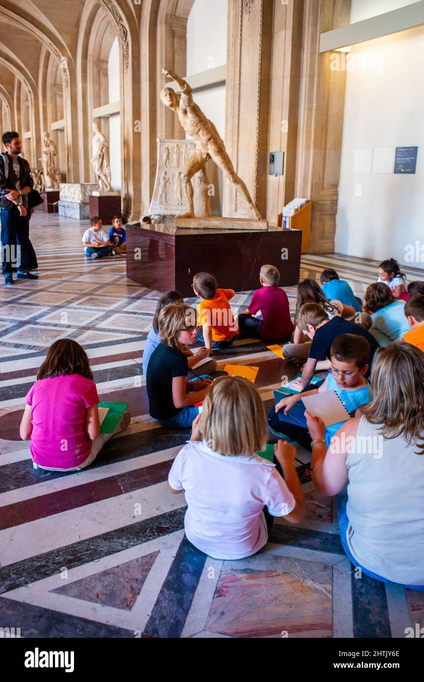 Paris, France, Grands groupes, enfants, enfants, assis sur l'étage dans le hall, avec professeur, regardant Gladiator de combat, Borghèse, Statue (Agasias d'Ephese, 1e-2e c. AC, Italie) à l'intérieur du Musée du Louvre sur l'affichage, musée des étudiants Banque D'Images