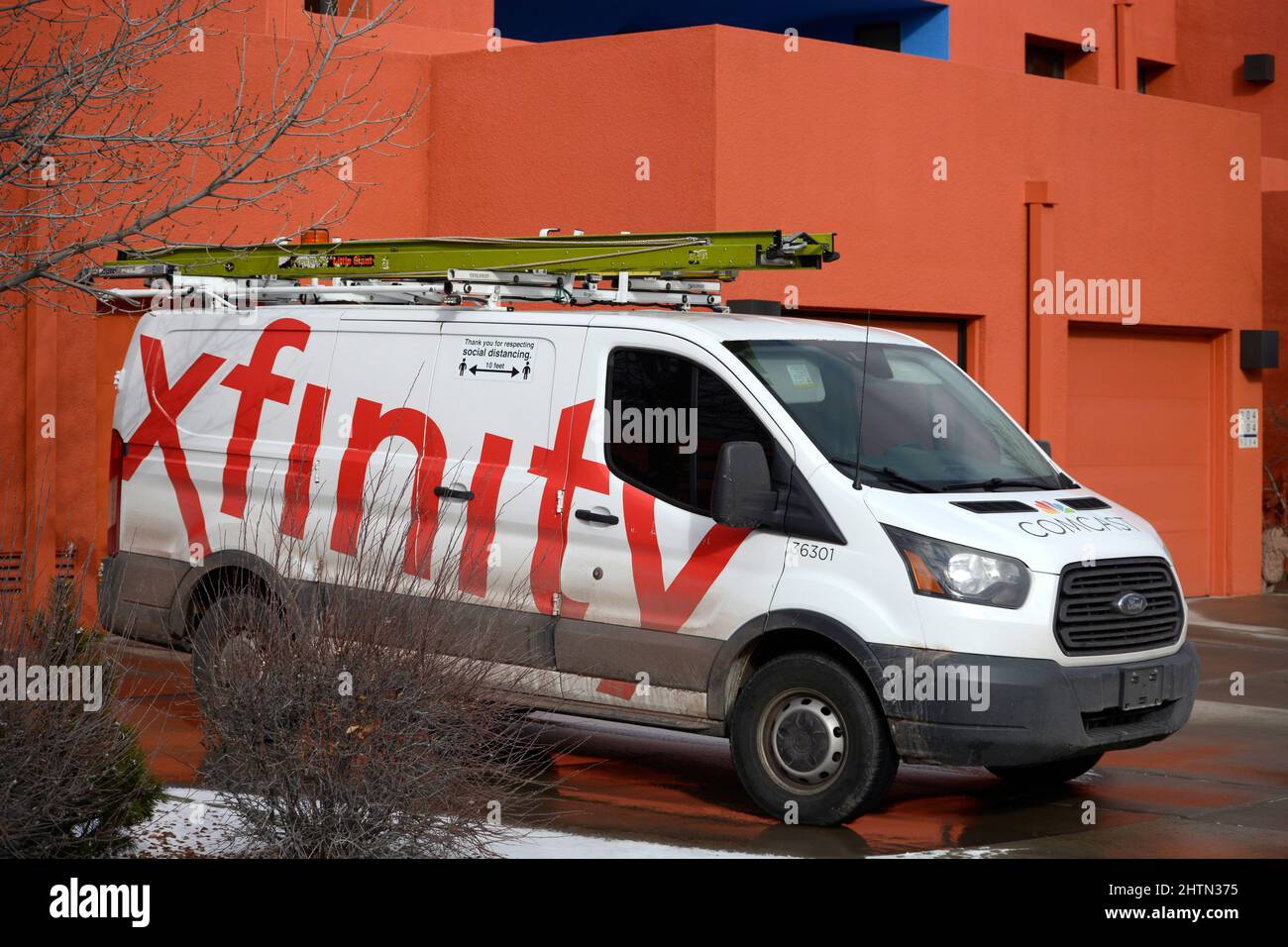 Un technicien de service Xfinity installe une ligne de télévision par câble dans une maison de Santa Fe, au Nouveau-Mexique. Banque D'Images