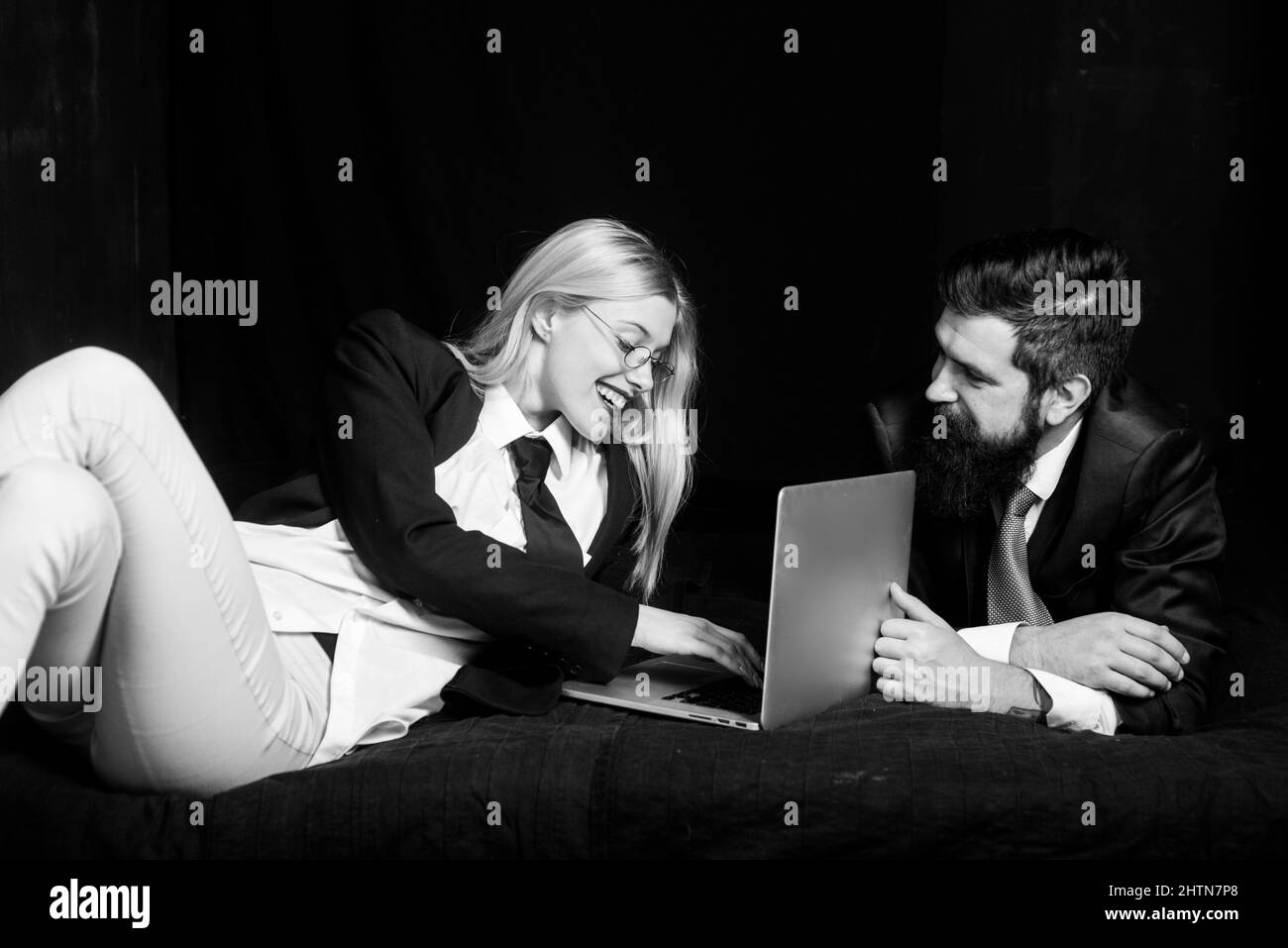 Couple regarder l'écran d'ordinateur portable, excitée jeune mari et femme utilisant l'ordinateur portable, la lecture des nouvelles, les achats en ligne.Un jeune couple navigue sur Internet Banque D'Images