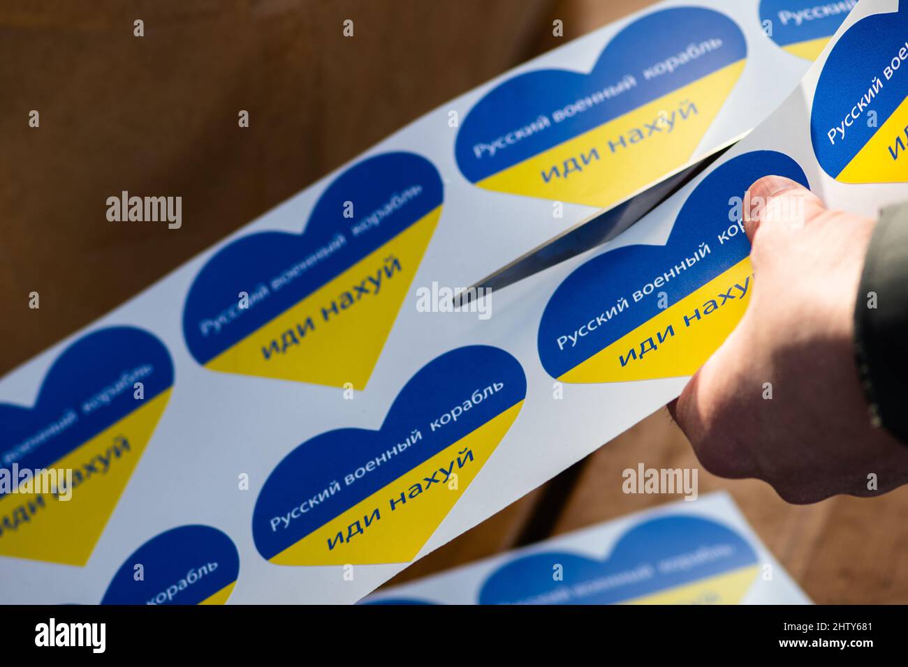 Préparer des autocollants en forme de coeur avec les couleurs de l'Ukraine lors d'une manifestation pacifique contre la guerre, Poutine et la Russie. Lettres cyrilliques Banque D'Images