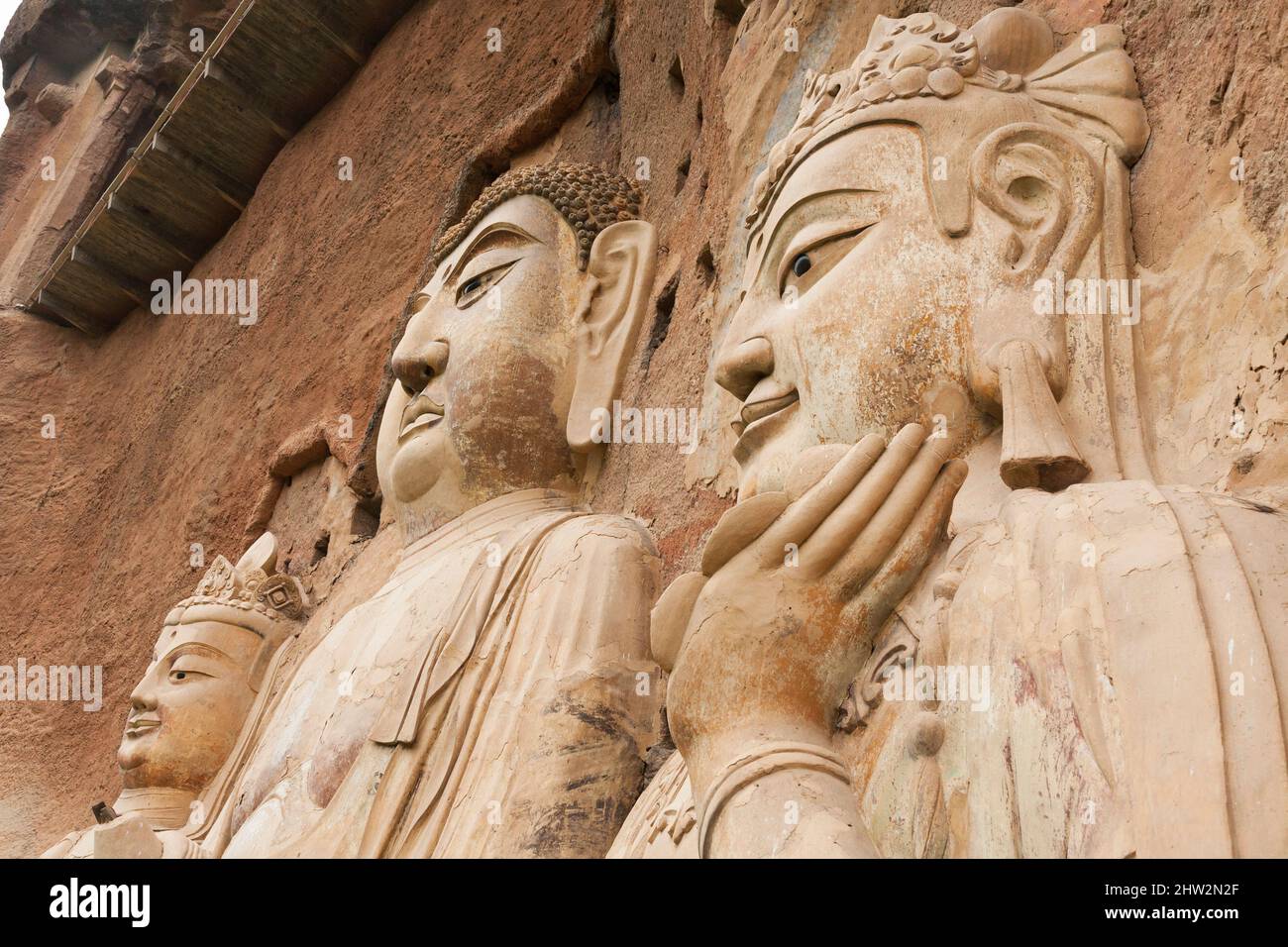 Représentations de Bouddha figures représentations et images bouddhistes (qui semble être restauré très récemment à l'aide de nouveaux matériaux) sur la face rocheuse des grottes de Maijishan, autrefois romanisée comme Maichishan, Qui sont une série de 194 grottes coupées sur le flanc de la colline de Majishan à Tianshui, province de Gansu, Chine. Des escaliers et des passerelles sont fixés à la face de roche pure pour permettre aux visiteurs d'entrer en contact étroit avec les figures d'argile et les anciennes sculptures en pierre sur le site. (67/125) Banque D'Images