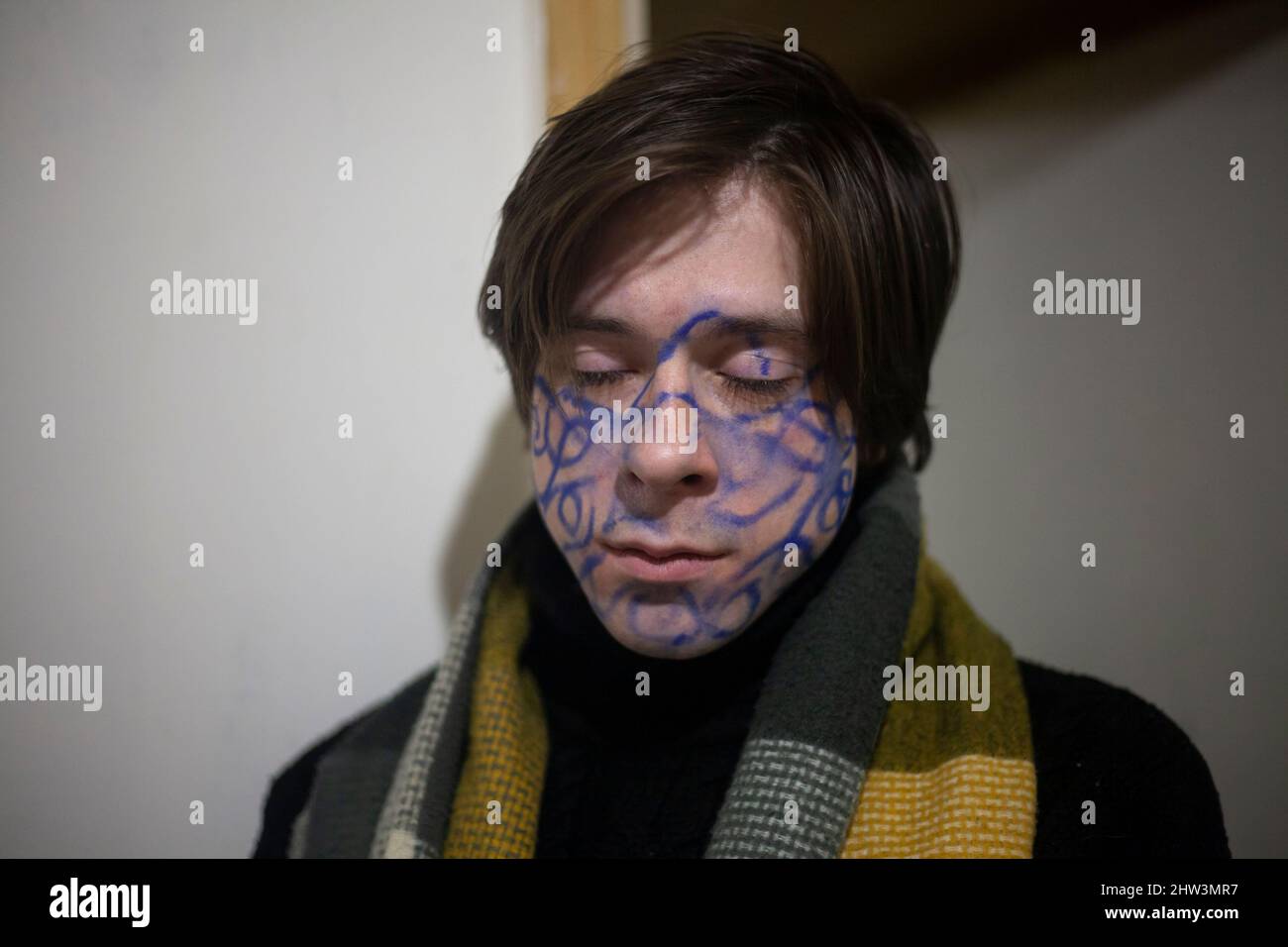 Un gars avec des dessins sur son visage. Roi de la fête. Le chercheur spirituel est fou. Un jeune homme avec une photo sur son visage. Homme d'affaires de Pottert. Un sous Banque D'Images