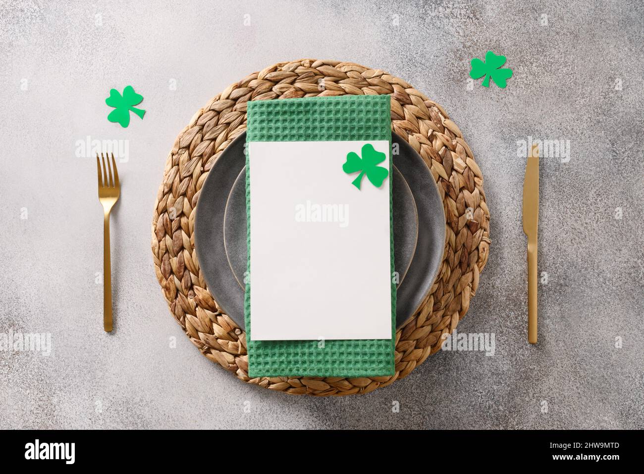 Table de Saint-Patrick avec décor vert traditionnel et menu sur fond gris. Vue de dessus. Copier l'espace. Banque D'Images