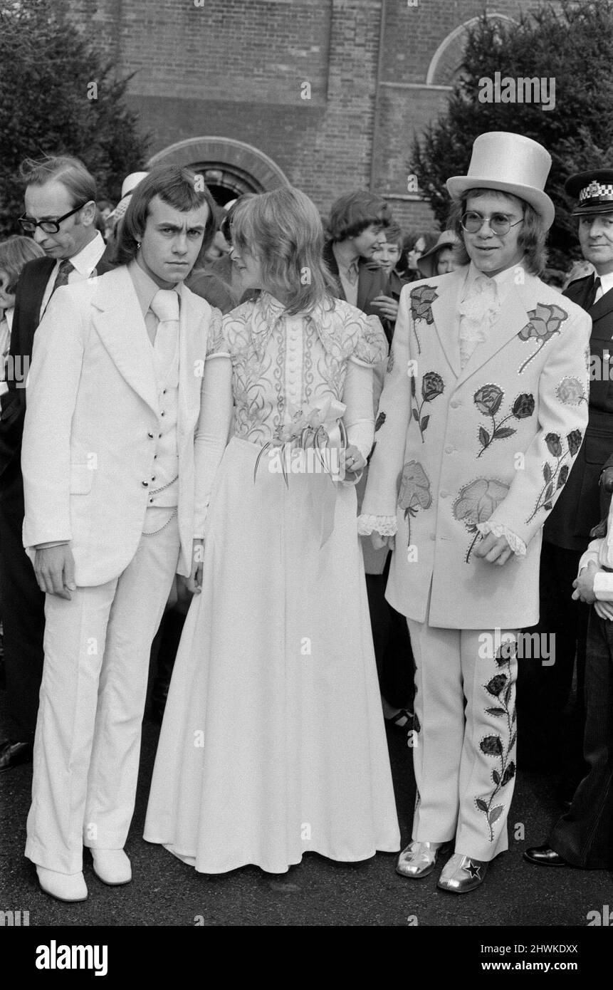 Elton John (à droite) est représenté ici comme le meilleur homme de son partenaire compositeur Bernie Taupin. Bernie épouse Maxine Feibelman, étudiante américaine de 19 ans, le samedi 27th mars 1971, à l'église catholique Holy Rood, à Market Rasen, Lincolnshire. Le meilleur homme Elton porte un costume blanc brodé de roses rouges et jaunes et un chapeau en soie blanche. Tous fabriqués à Los Angeles, par le même tailleurs qui a conçu des costumes pour Elvis Presley. (Le taiser est nommé en sous-titrage mais écrit difficile à faire) Bonde Maxine, porte une grande robe traditionnelle en blanc avec de vieux iris d'or embroidés sur le bodyl. Marié Banque D'Images