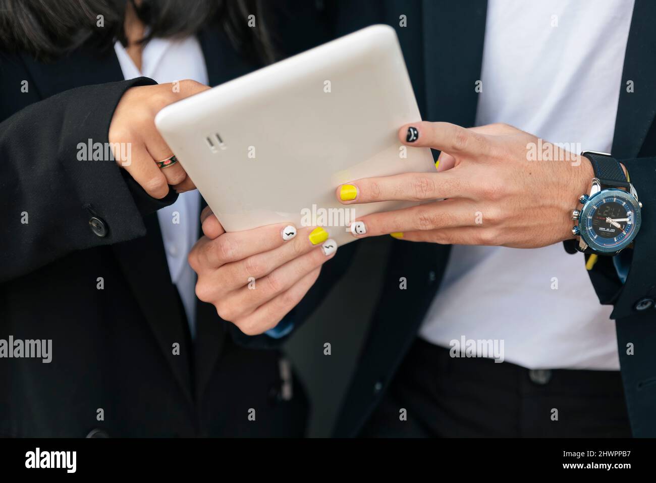 Homme d'affaires avec clou peint utilisant un PC tablette avec un collègue Banque D'Images