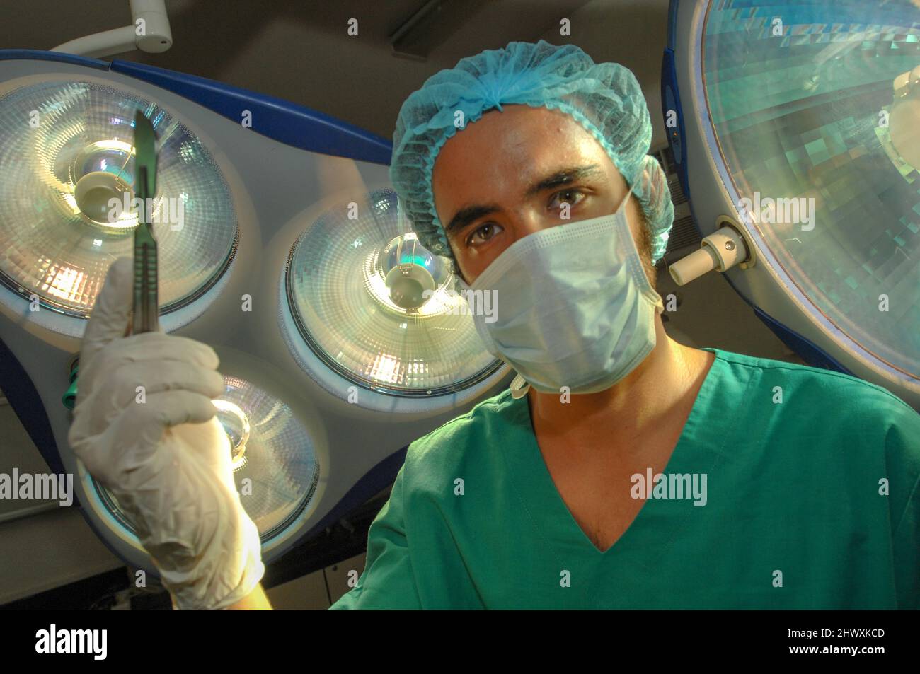 Gros plan d'un chirurgien de l'hôpital tenant un scalpel sous les lampes de la salle d'opération (MODÈLE RELÂCHÉ) Banque D'Images
