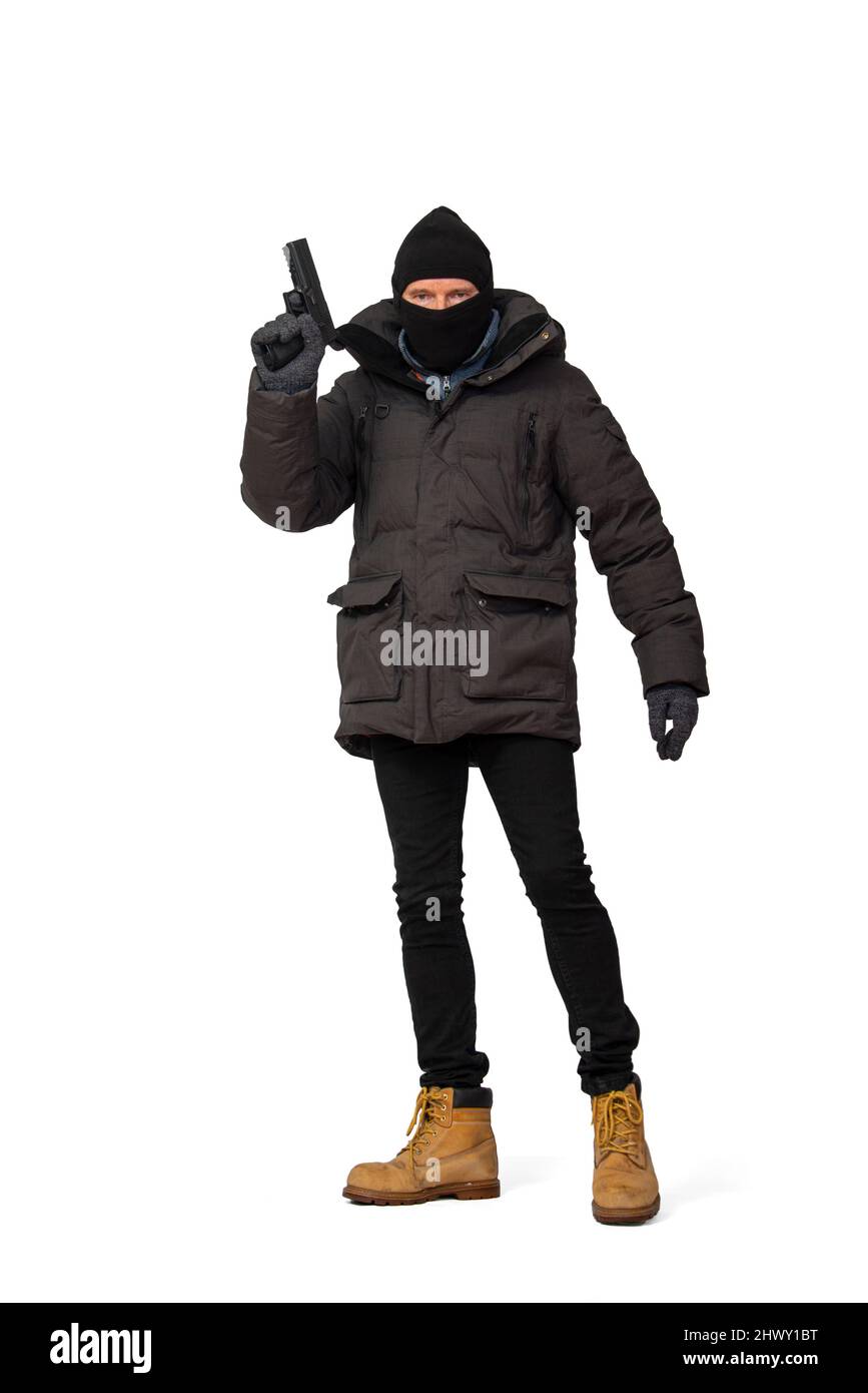 Homme vêtu de noir tenant un fusil, Banque D'Images
