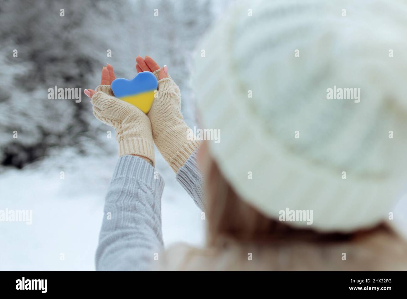 Pas de guerre. Février le début de la guerre en Ukraine la jeune fille tient un coeur d'une couleur bleue pathétique dans ses mains. La paix en Ukraine Banque D'Images