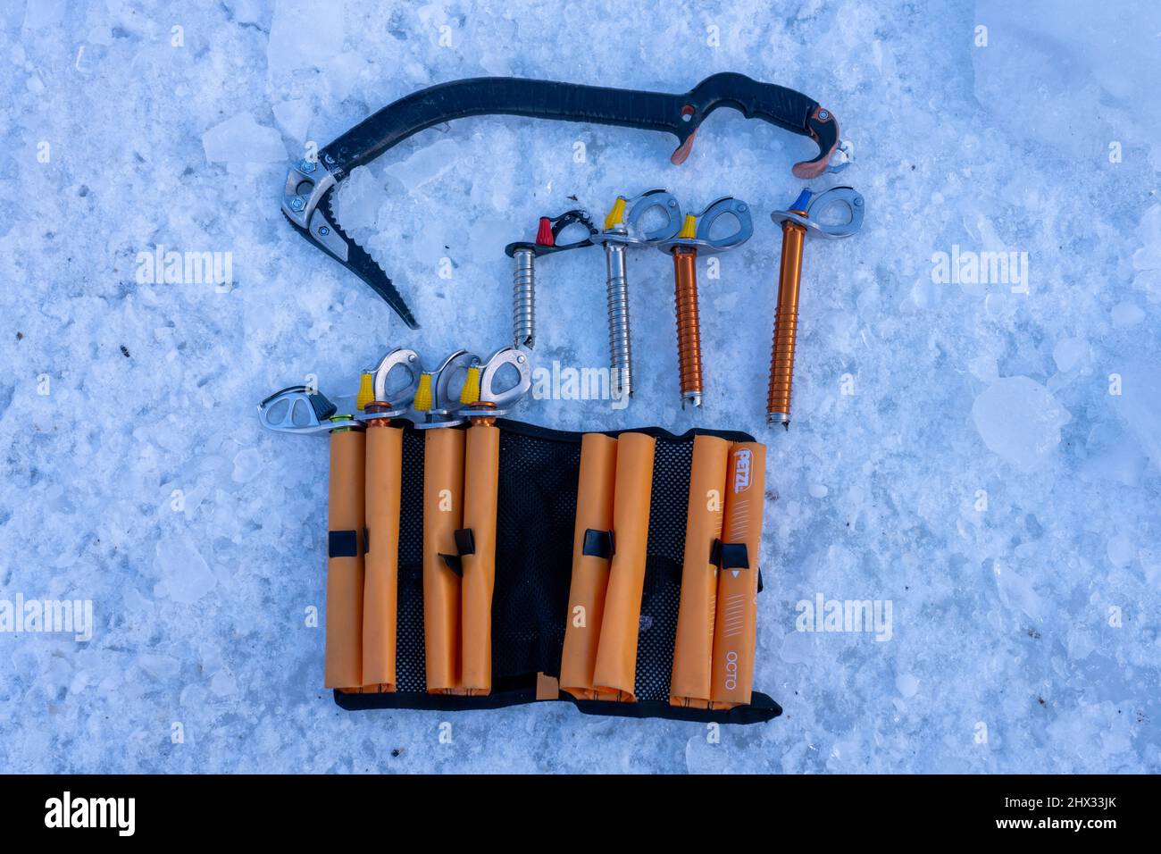 Un jeu de vis à glace ou d'ancrages à glace avec une hache à glace pour installer des ancrages de protection dans un mur à glace pendant l'escalade de glace. Ouray, Colorado. Banque D'Images
