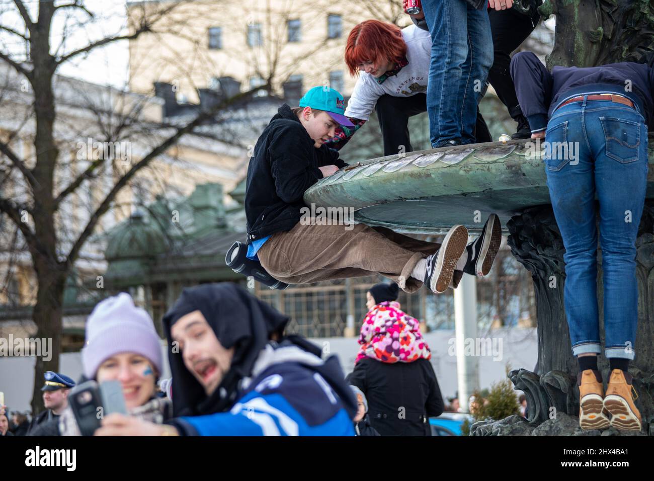 Des jeunes grimpent sur la sculpture en bronze Havis Amanda pour célébrer la médaille d'or olympique du hockey sur glace à Helsinki, en Finlande Banque D'Images