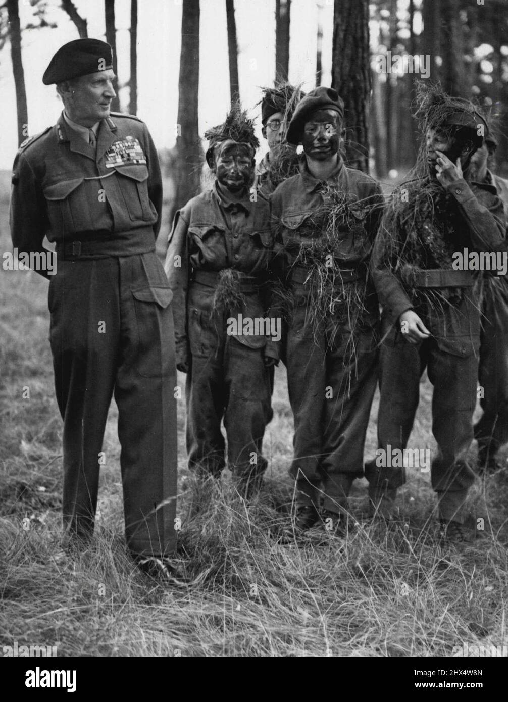 Cadets de visite 'Monty': C. I. G. S. Field Marshal Montgomery prend un regard réfléchi sur quelques jeunes cadets de la Force des cadets de l'Oxfordshire, qui, avec des visages obscurcis avec le camouflage, s'entraîne au Camp de Parkhurst Tidworth. Les jeunes prennent leur formation au sérieux et ont reçu des mots d'encouragement du maréchal. 6 août 1948. (Photo de Reuterphoto) Banque D'Images