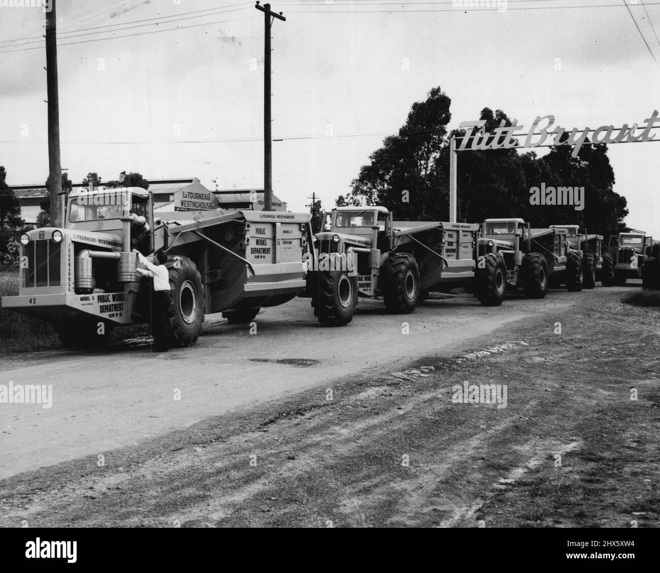 Hier, ces cinq géants du terrassement ont pris la route des Snowy Mountains. Il s'agit du premier des vingt-cinq £12 000 Tournapulls construits en Australie commandés pour utilisation par le ministère des travaux publics sur le projet de barrage d'Adaminaby du Snowy Mountains Scheme. Ces machines LeTourneau-Westinghouse, chacune capable de transporter 18 tonnes de terre et de roche et pouvant atteindre des vitesses de 30 m/h, seront utilisées sur les 11 000 000 yards cubes de mur de barrage de terre, 390 pieds de haut, 2 200 pieds d'épaisseur à la base Banque D'Images