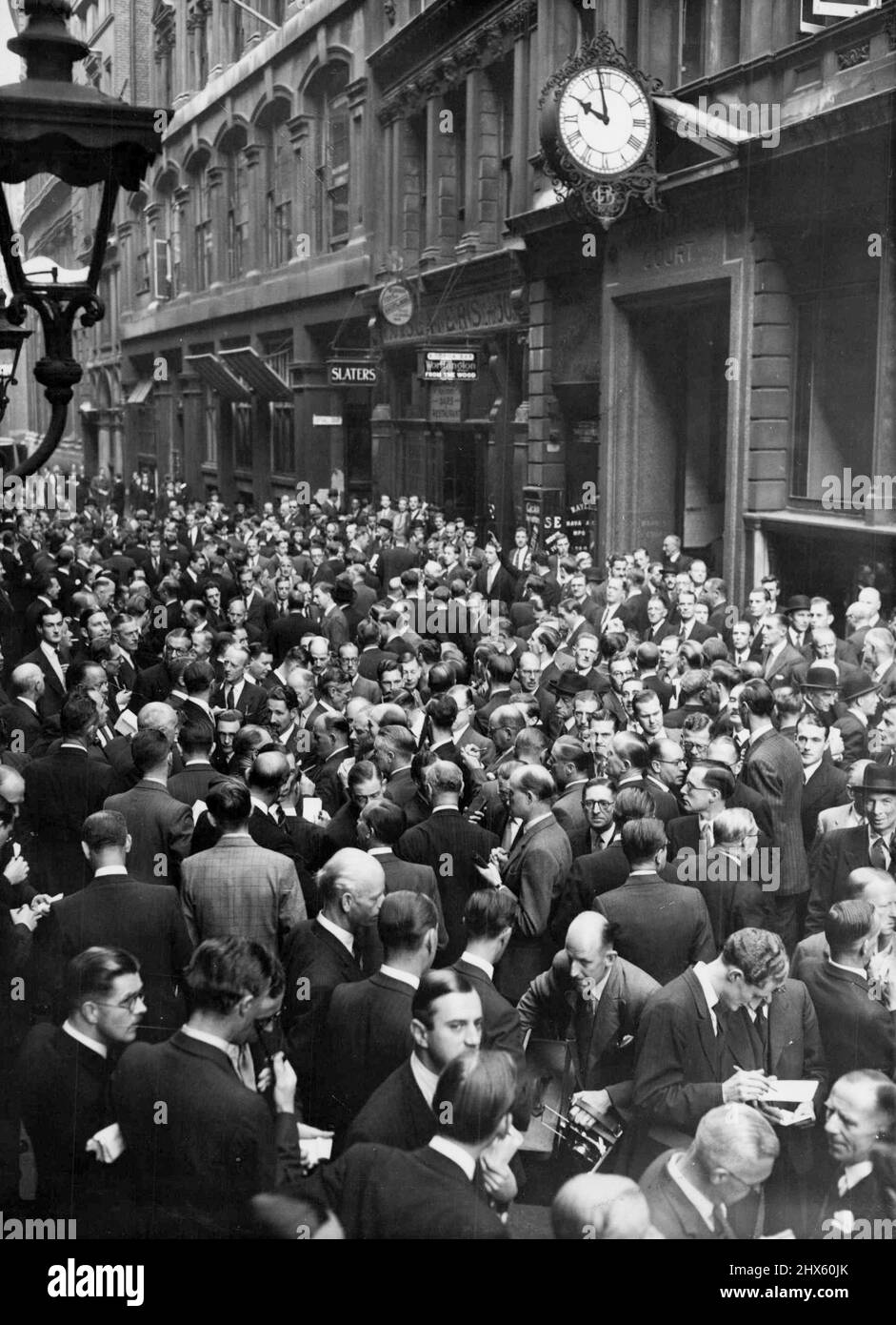 La dévaluation de la livre sterling ferme les banques - les membres de la Bourse, les jobbers et les financiers emballez la rue devant la Bourse de Londres aujourd'hui 19 septembre. Les banques et les bourses britanniques ont été fermées par proclamation royale aujourd'hui 19 septembre après l'annonce par le trésor de la dévaluation de la livre, le 18 septembre. Des foules de courtiers en Bourse et d'ouvriers ont envahi les rues de la City à Londres, attendant de nouveaux développements dans la situation financière. 19 septembre 1949. (Photo par photo de presse associée). Banque D'Images