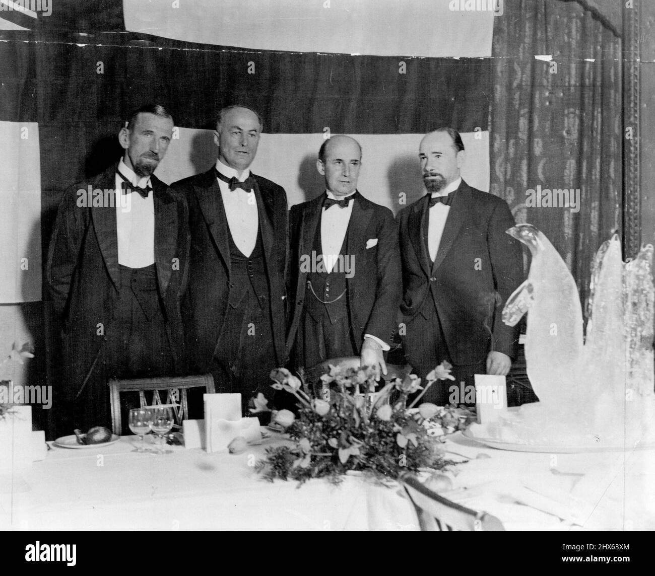 Le Club antarctique a donné un dîner ce soir, le 8th mai. Au Caffe Royal, à Sir Douglas Mawson avant son départ pour l'Antarctique sur le célèbre navire du Capt Scott, la 'découverte'. De gauche à droite : le capitaine J. H. Davis, sir Douglas Mawson, le vice-amiral R. W. Skelton et Hubert Wilkins à droite sont un pingouin dans la glace. 8 juin 1929. Banque D'Images