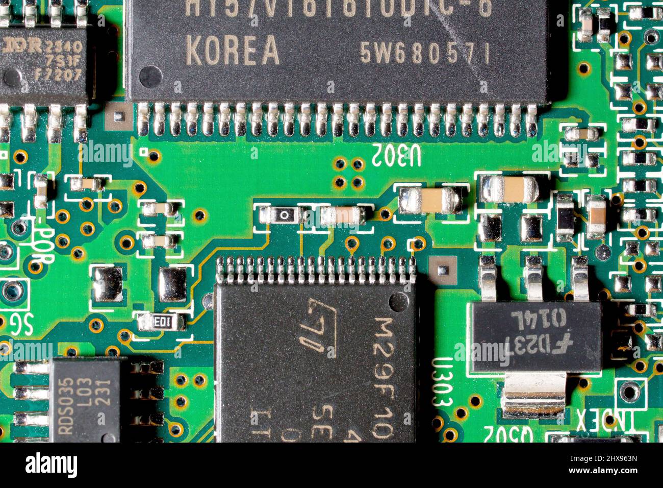 Gros plan d'une carte de circuit imprimé d'ordinateur, montrant différentes tailles de puces intégrées et d'autres composants électroniques. Banque D'Images