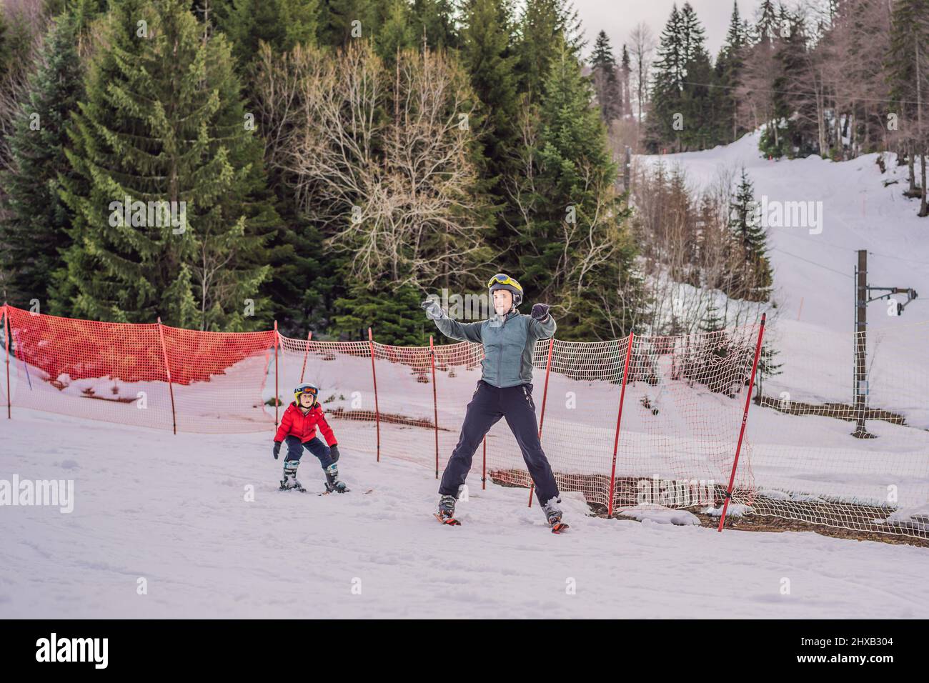 Garçon apprenant à skier, à s'entraîner et à écouter son instructeur de ski sur la piste en hiver Banque D'Images