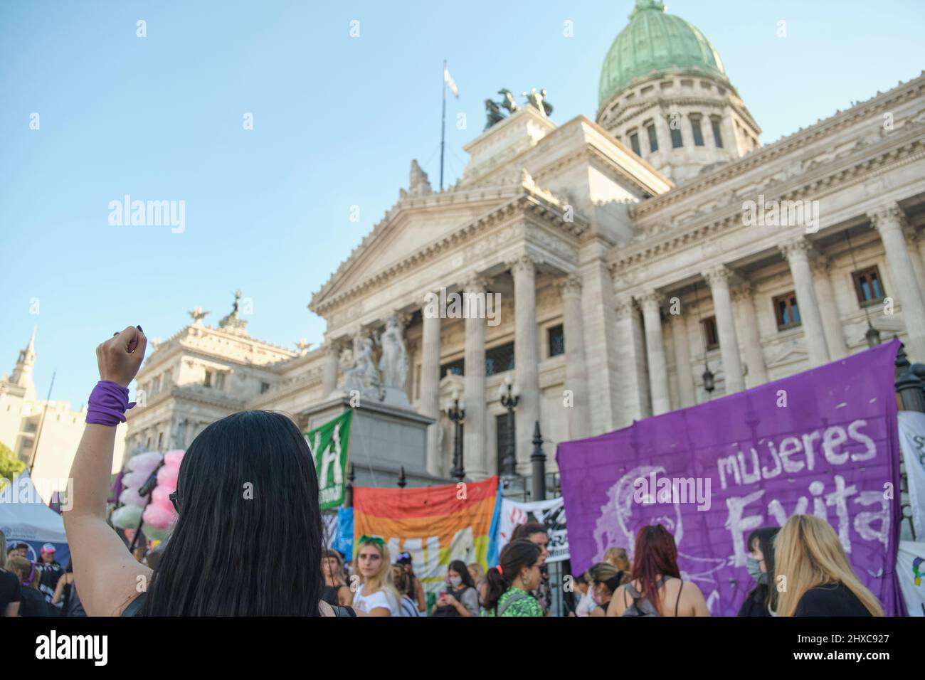 Buenos Aires, Argentine; 8 mars 2022: Grève féministe internationale, femme méconnaissable élève sa poing avec un foulard violet, symbole des féministes Banque D'Images