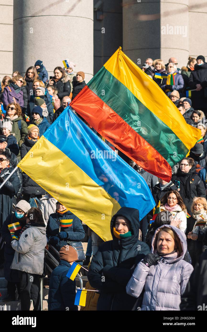 Manifestation pacifique contre la guerre, Poutine et la Russie en faveur de l'Ukraine avec des personnes avec des drapeaux ukrainiens et lituaniens, vertical Banque D'Images