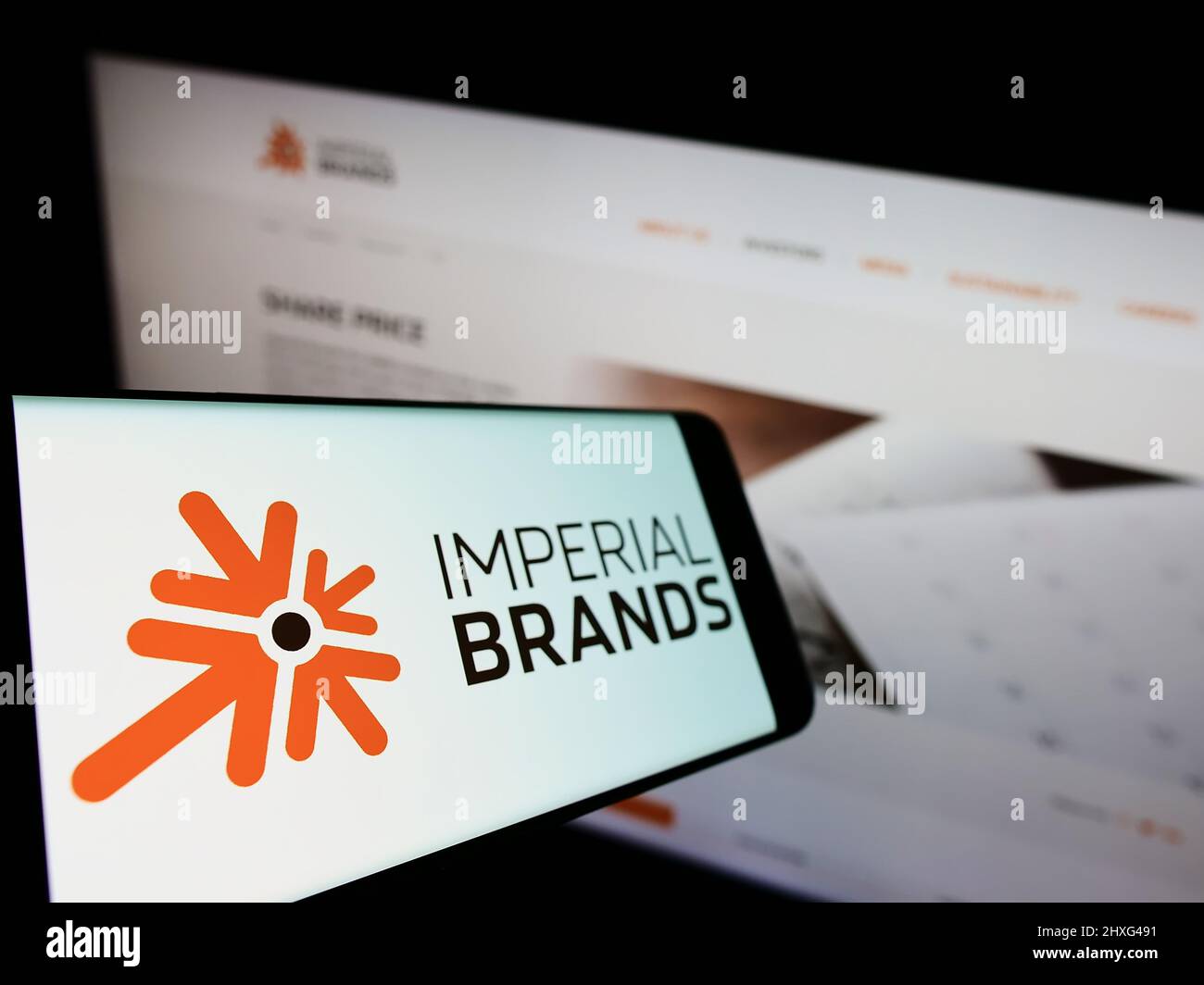 Smartphone avec le logo de la société britannique de tabac Imperial Brands plc à l'écran devant le site Web d'affaires. Mise au point au centre-gauche de l'écran du téléphone. Banque D'Images