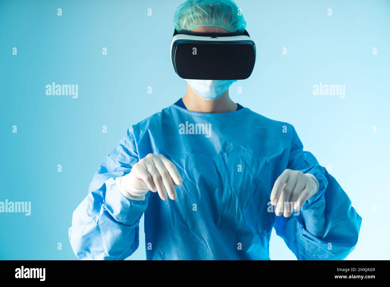 Médecin caucasien utilisant le développement technologique, lunettes de réalité virtuelle. Prise de vue moyenne en studio, fond bleu. Photo de haute qualité Banque D'Images