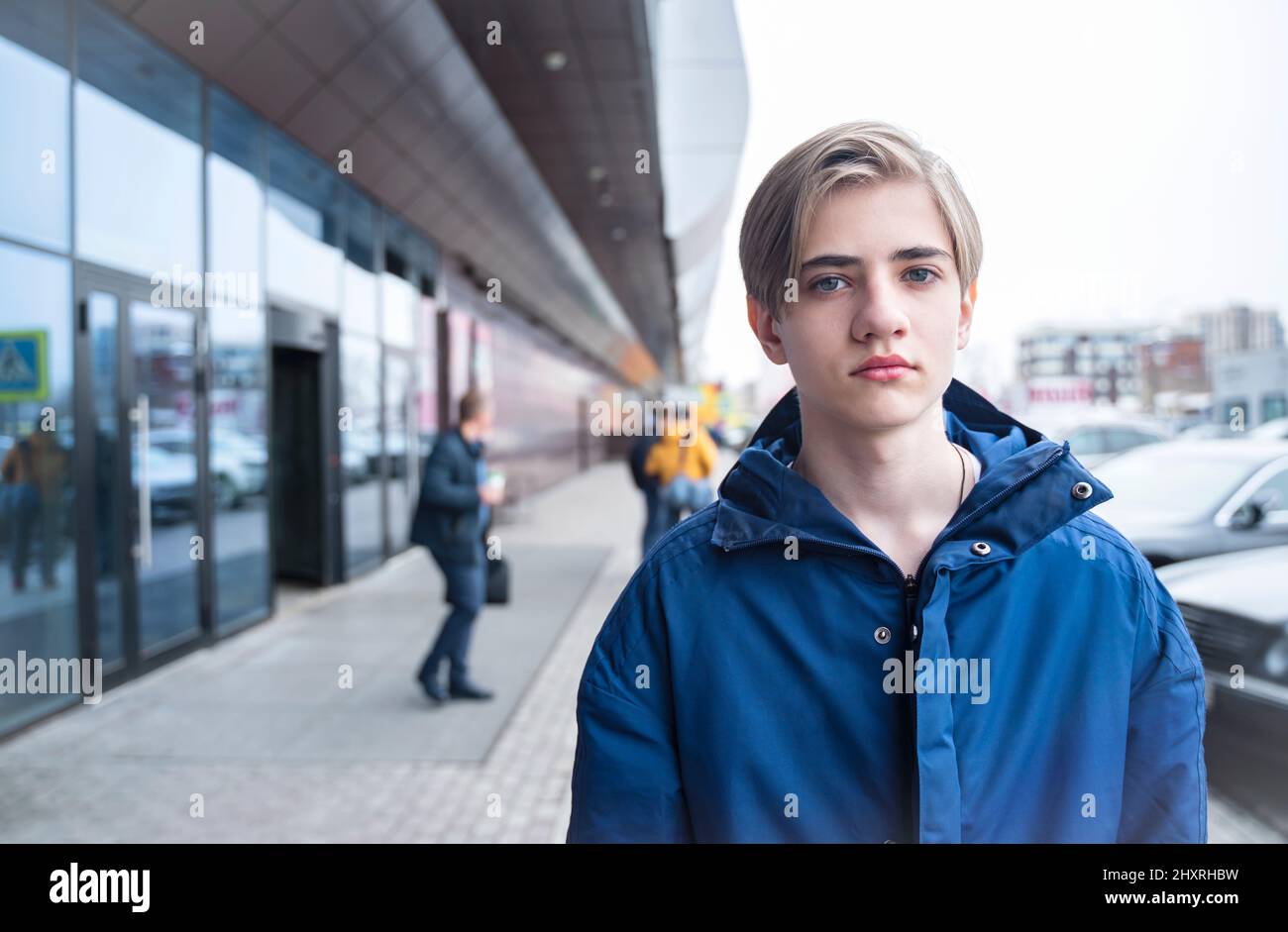 Portrait d'un adolescent. Un adolescent dans une veste bleue regarde la caméra. Banque D'Images