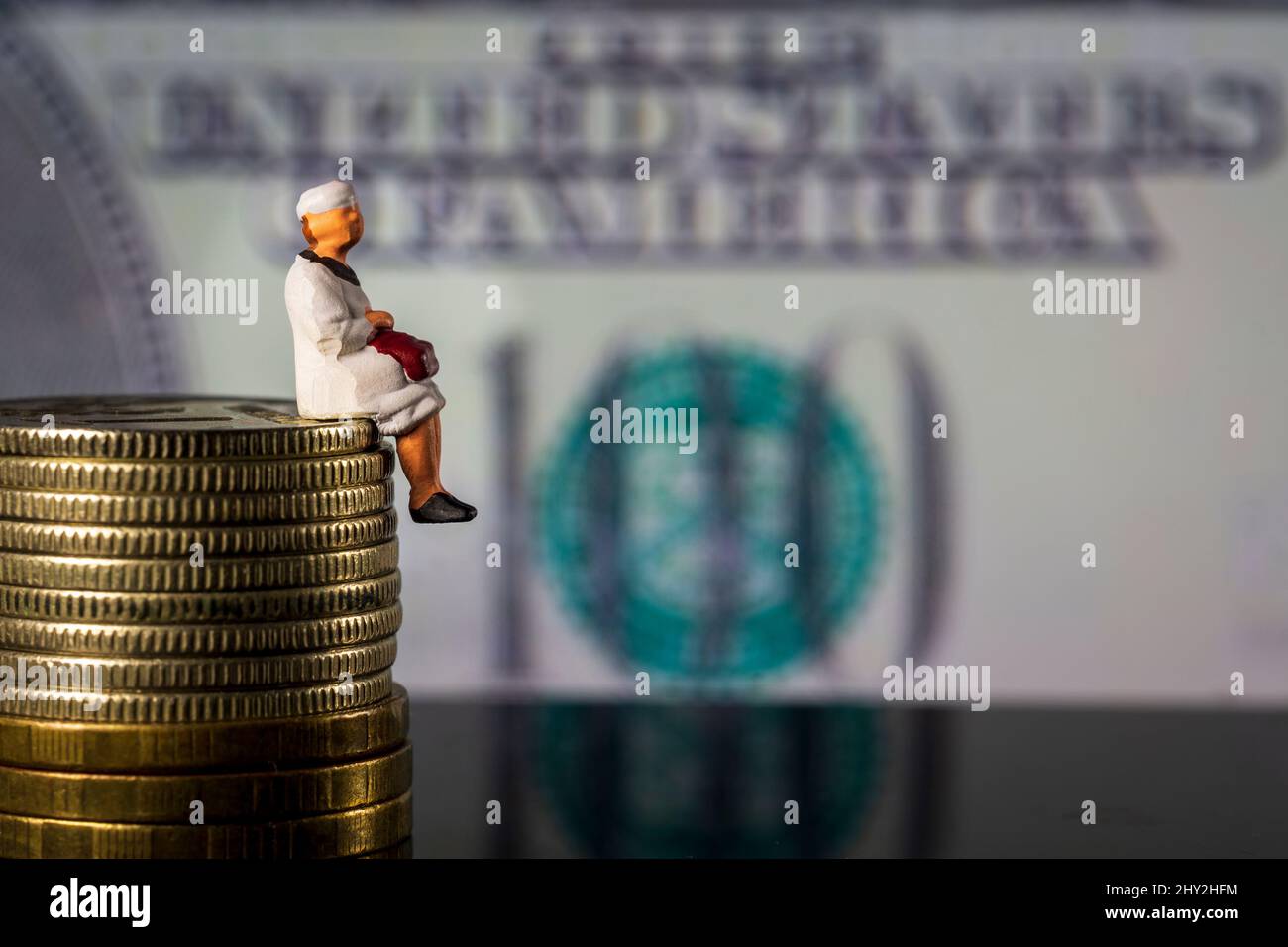 Retraité assis sur la pile d'argent symbole photo pour la pension, la retraite, la vieillesse Banque D'Images