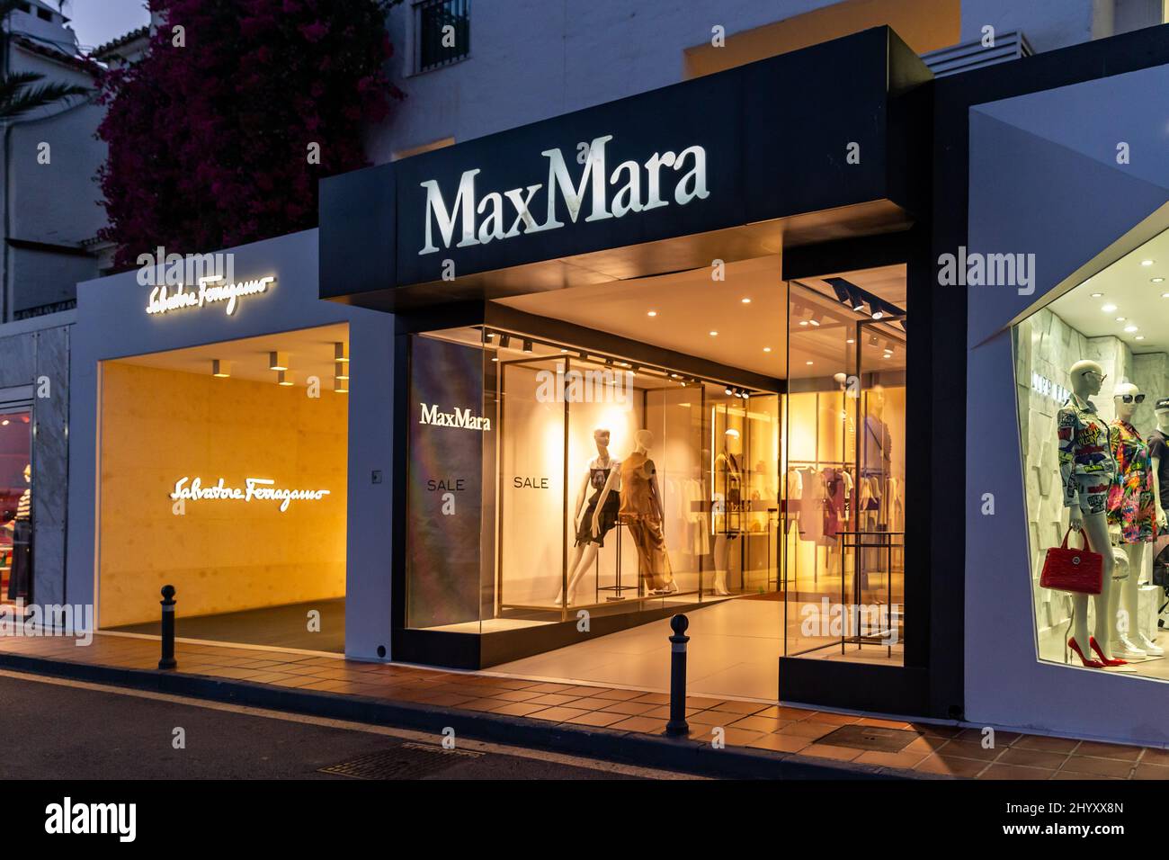 Photographie de nuit dans le luxe et célèbre emplacement de Marbella - baie de Puerto Banus. Vue sur le magasin Max Mara, dans la zone commerçante du port. Banque D'Images