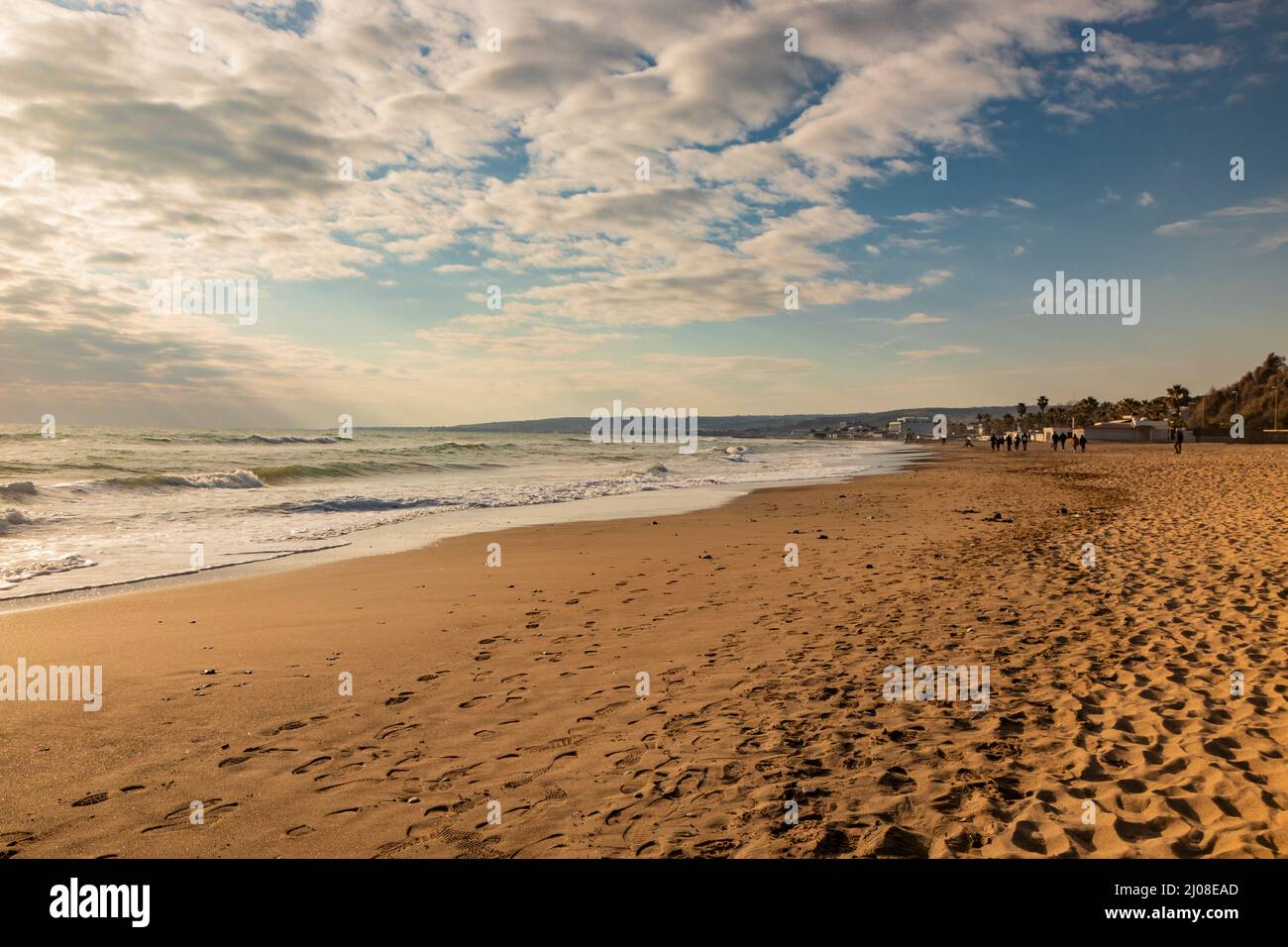 Santa Marinella, Rome, Lazio, Italie - bord de mer de la côte romaine de Santa Severa, le jour d'hiver. Beaucoup de gens se promènent et profitent du soleil sur la plage, Banque D'Images