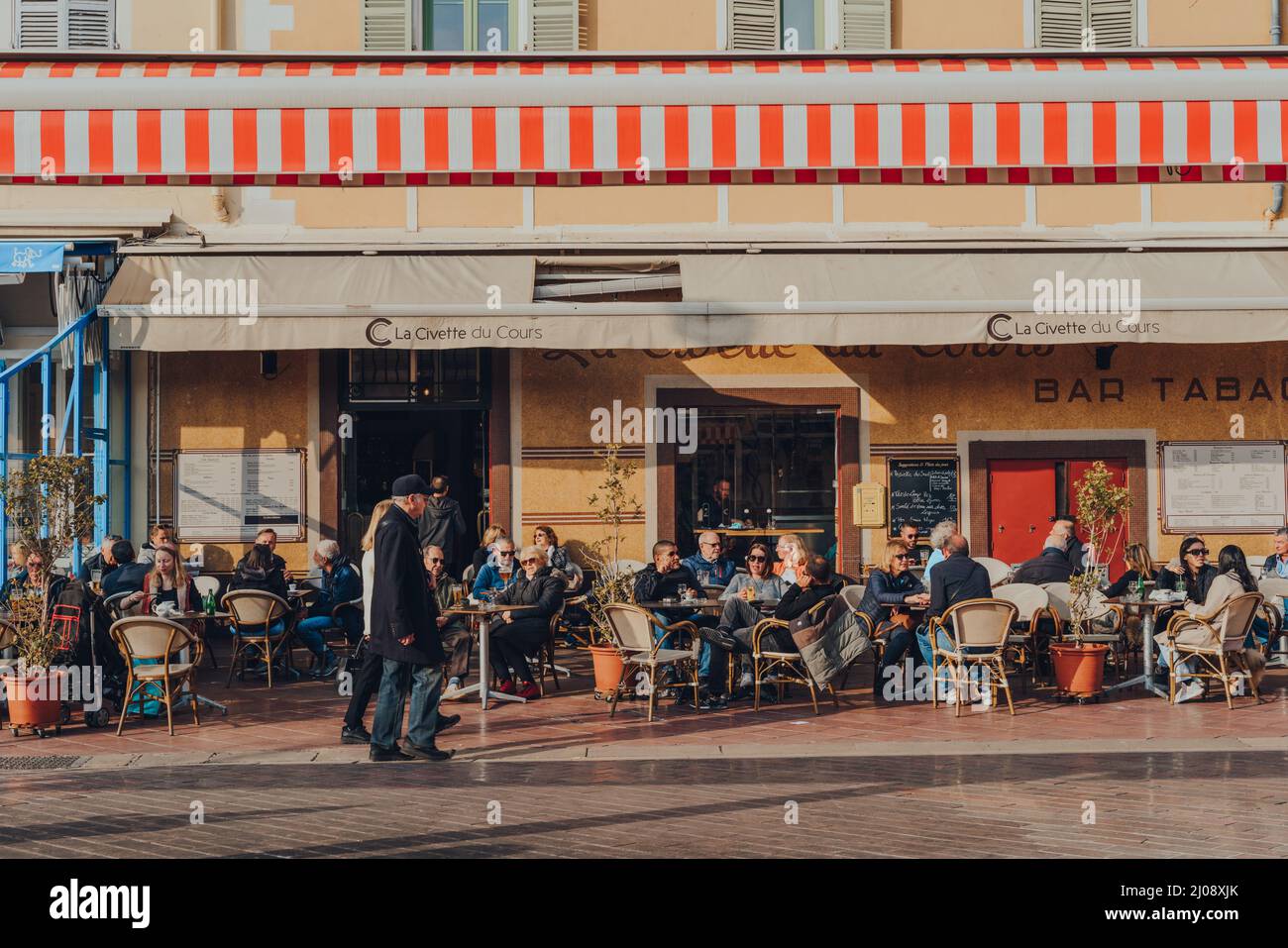 Nice, France - 10 mars 2022 : personnes assises à la table extérieure du restaurant la Civette du cours sur le cours Saleya, une rue de la vieille ville de Nice Banque D'Images