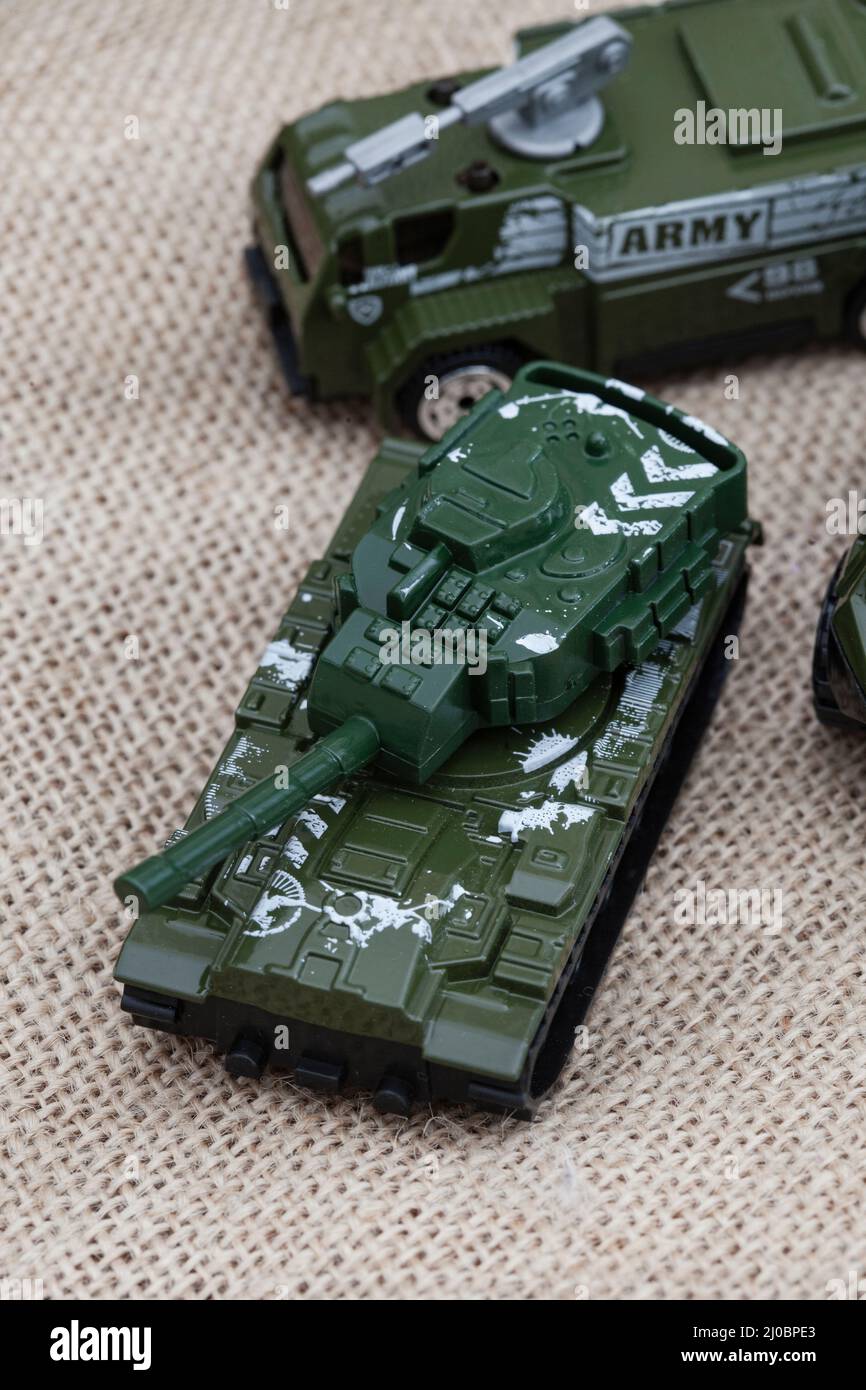 ours en peluche de style rustique sur un tissu hessien et rugueux avec des jouets de guerre, illustrant une enfance pendant une période de guerre Banque D'Images