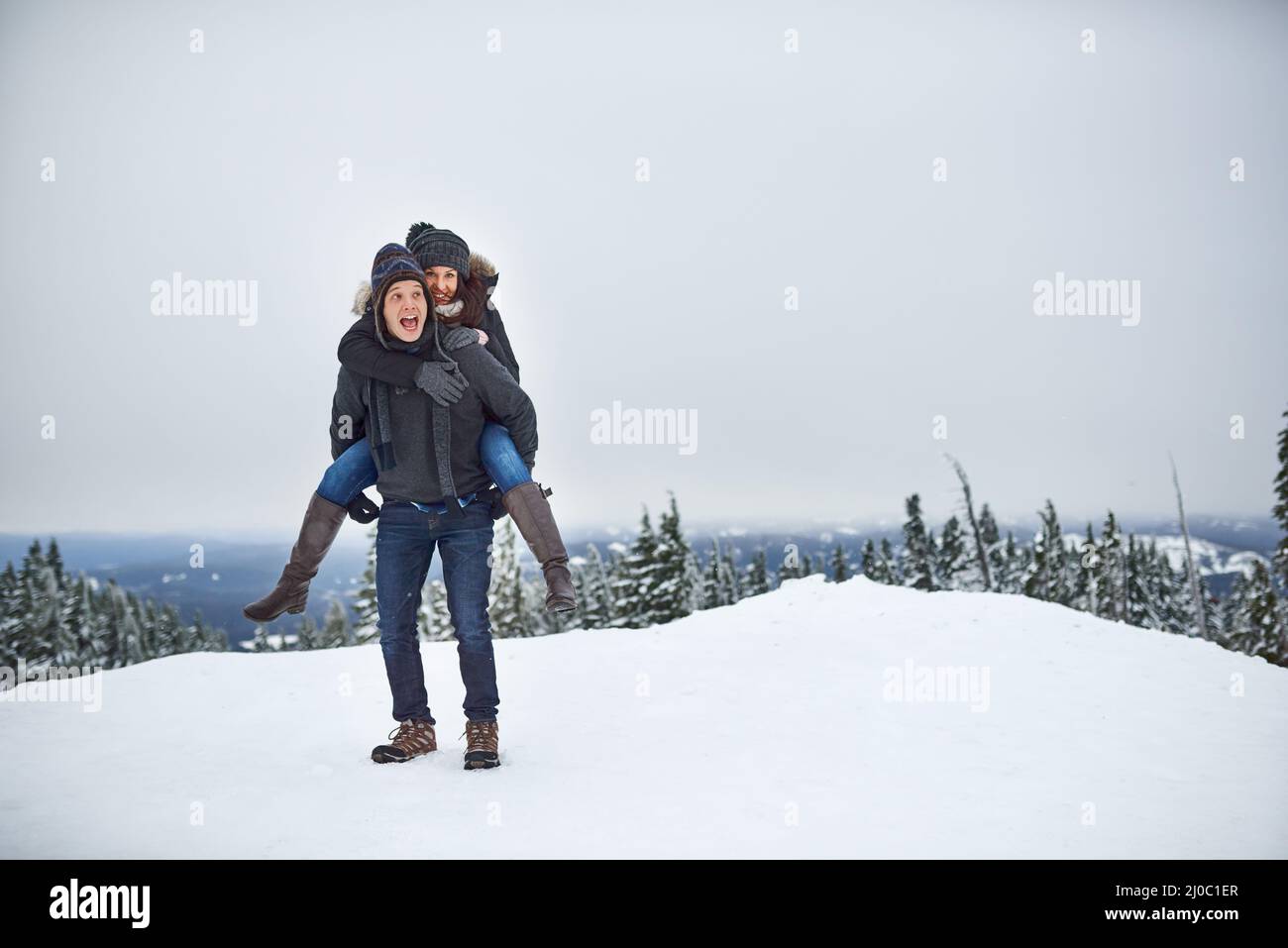 Ils étaient à la hauteur de la neige. Photo d'un jeune couple heureux s'appréciant tout en étant dehors dans la neige. Banque D'Images