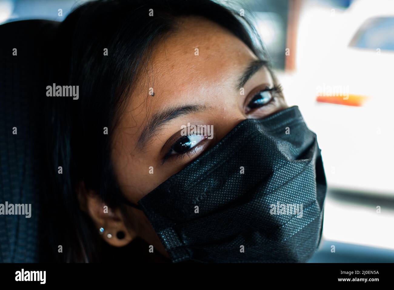 Femme souriant derrière le masque Banque D'Images