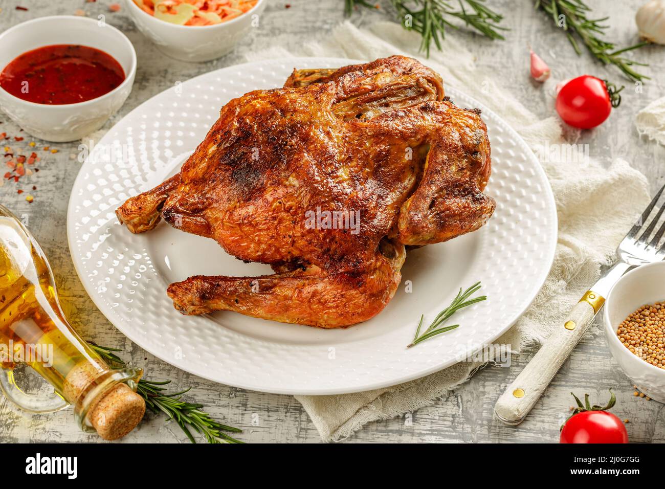 Tabaka de poulet rôti grillé dans une assiette blanche sur table en béton avec des wegetables et des épices Banque D'Images