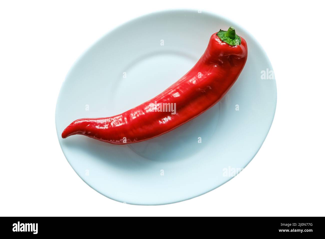 Le poivron rouge repose sur une assiette. Isoler. Banque D'Images