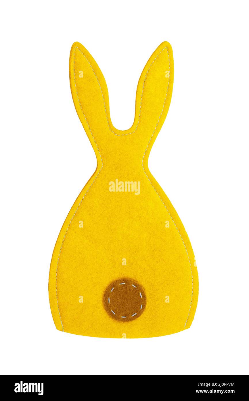 Lapin cousu en feutre jaune sur fond blanc isolé. Pâques, symbole de l'année Banque D'Images