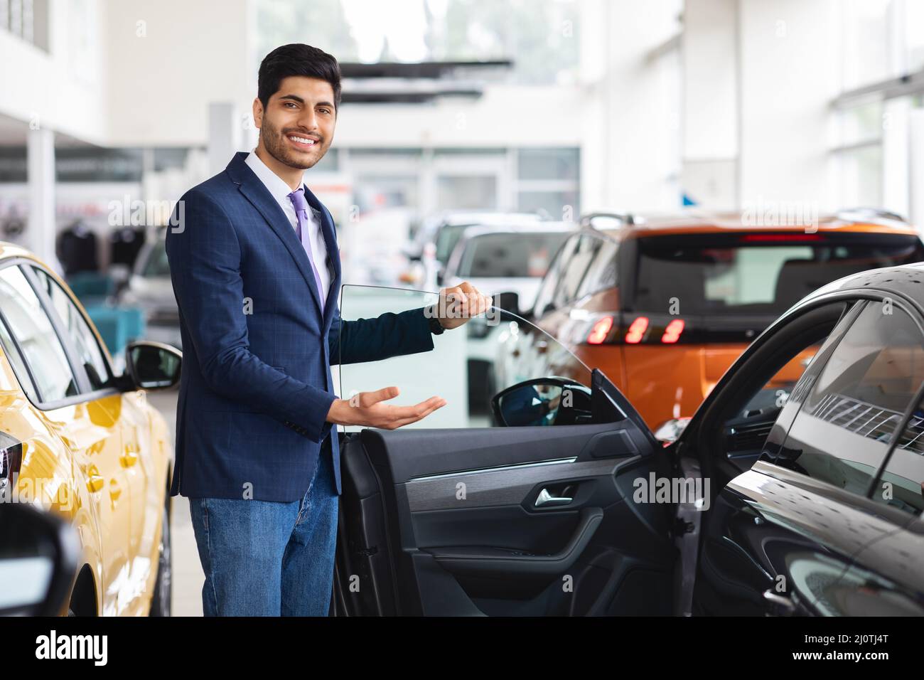 Le directeur des ventes du Moyen-Orient est souriant, montrant une voiture agréable Banque D'Images